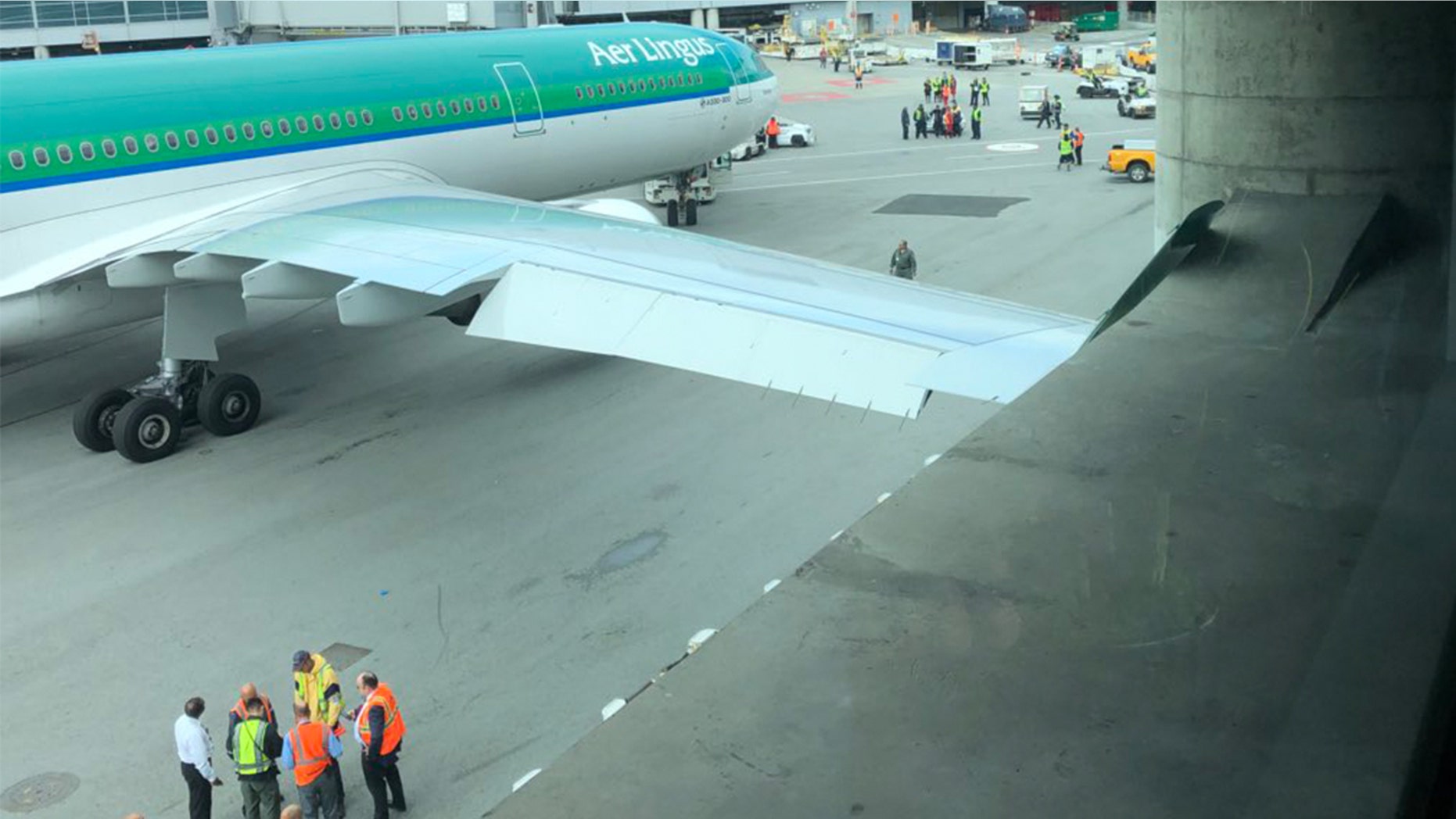 An airport worker at SFO towed an Aer Lingus plane into a concrete pole, resulting in damage to the wing.
