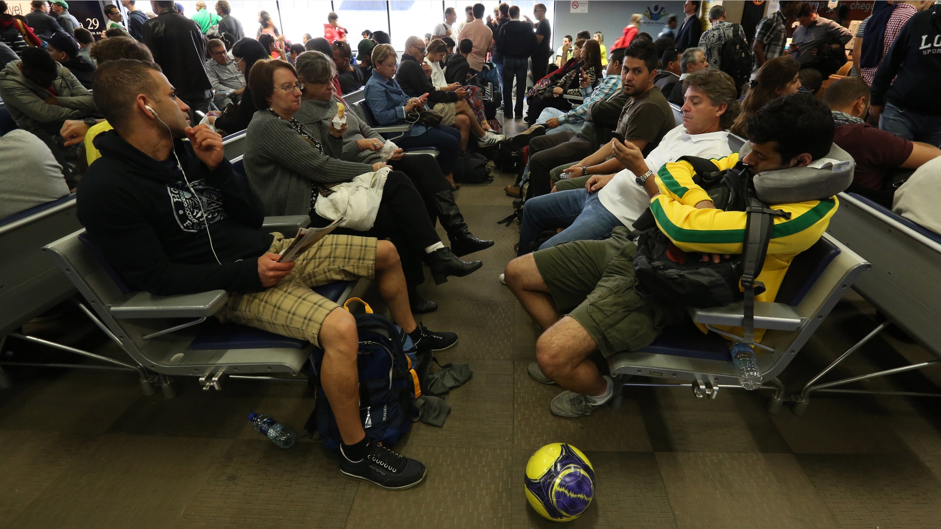 Passengers wait after flights were delayed due to heavy fog, in World Cup host city Curitiba, Brazil, June 17, 2014.