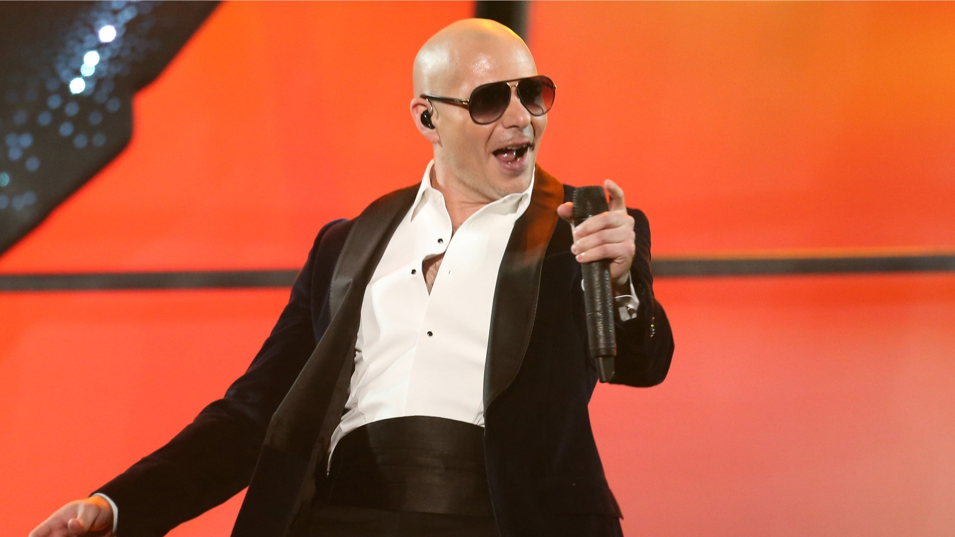 Pitbull performs at the 42nd annual American Music Awards at Nokia Theatre L.A. Live on Sunday, Nov. 23, 2014, in Los Angeles. (Photo by Matt Sayles/Invision/AP)