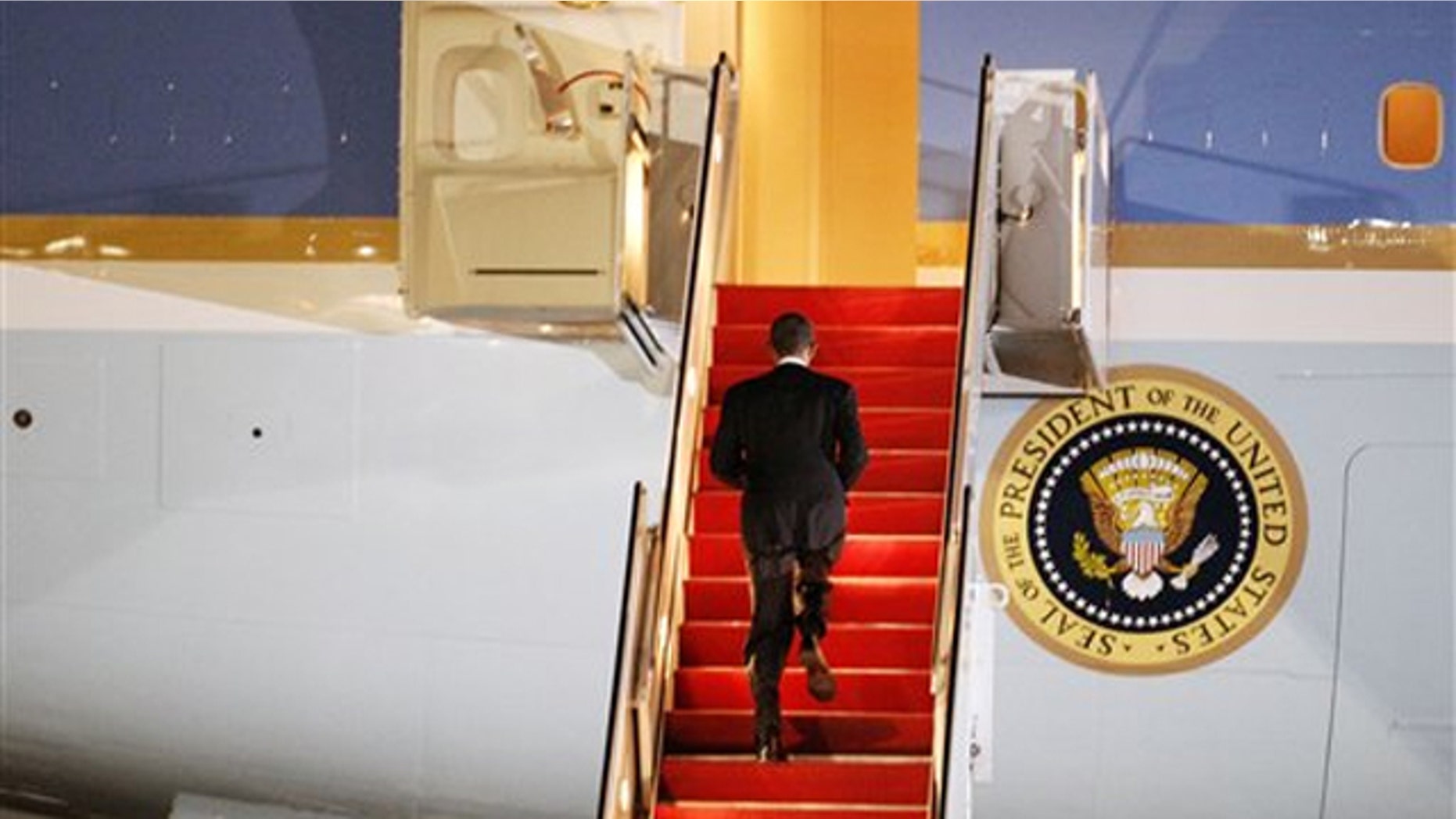 President Obama walks up the stairs of Air Force One before leaving for Lisbon, Portugal, at Andrews Air Force Base on Nov. 18. (AP Photo)