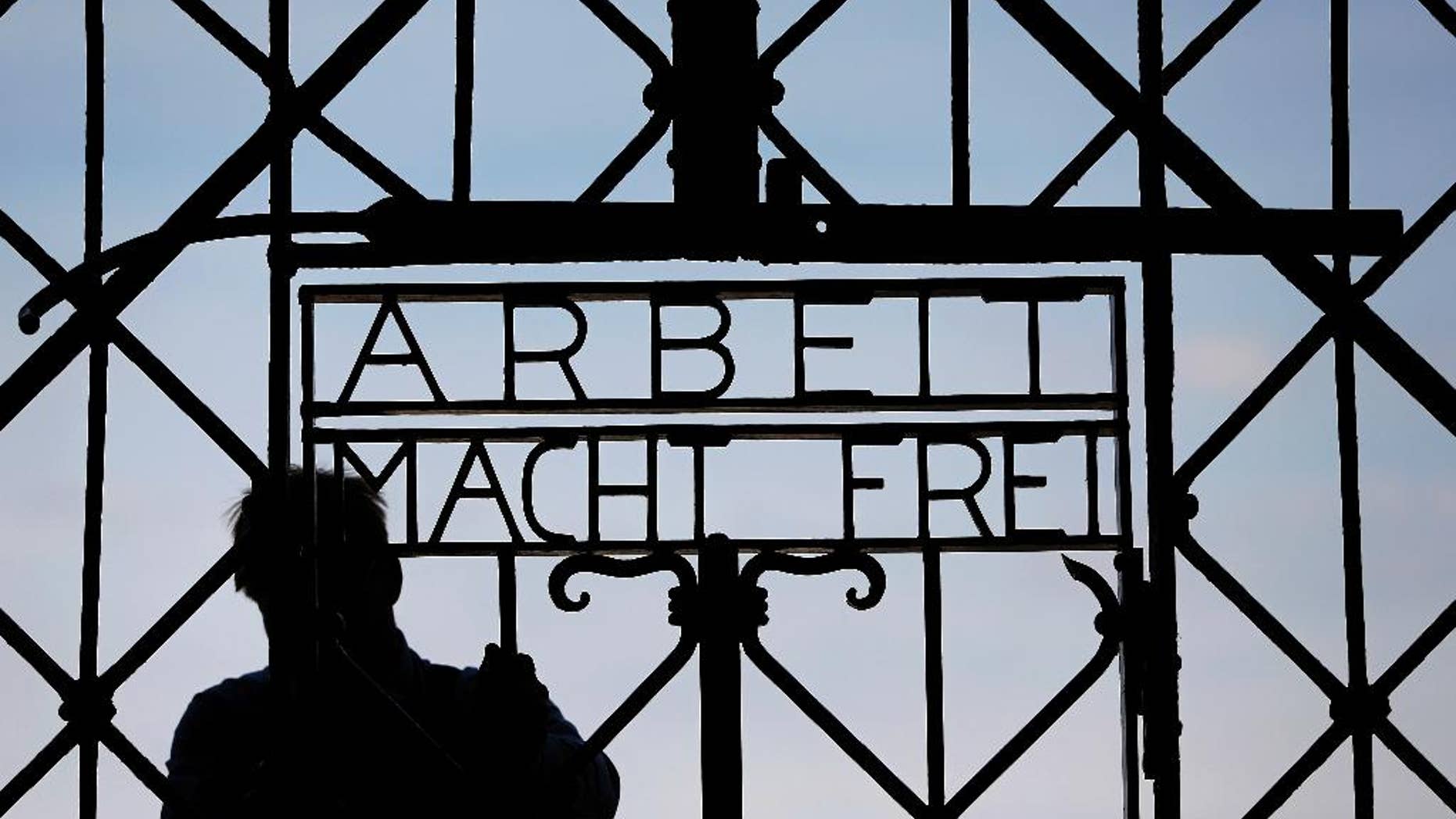 FILE In this April 29, 2015 file picture a blacksmith prepares a replica of the Dachau Nazi concentration camp gate, with the writing "Arbeit macht frei" (Work Sets you Free) at the main entrance of the memorial in Dachau, Germany,. German police say Friday Dec. 2, 2016 the wrought-iron gate to the Nazis’ Dachau concentration camp that was stolen two years ago appears to have been found in western Norway. (AP Photo/Matthias Schrader,File)