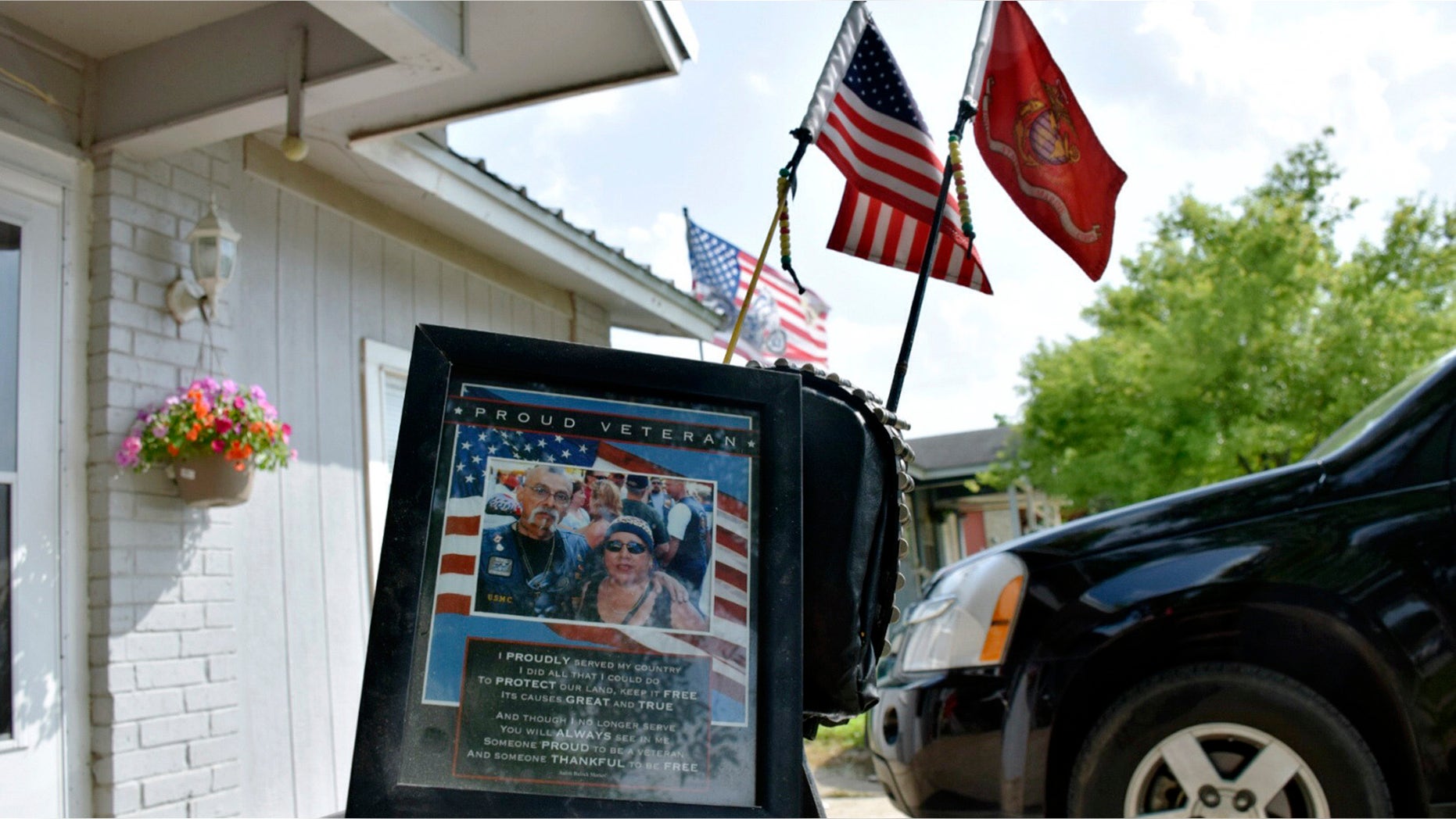 A portrait of Jesus Delgado Rodriguez rests on the seat of a motorcycle in front of his home in New Braunfels, Texas.