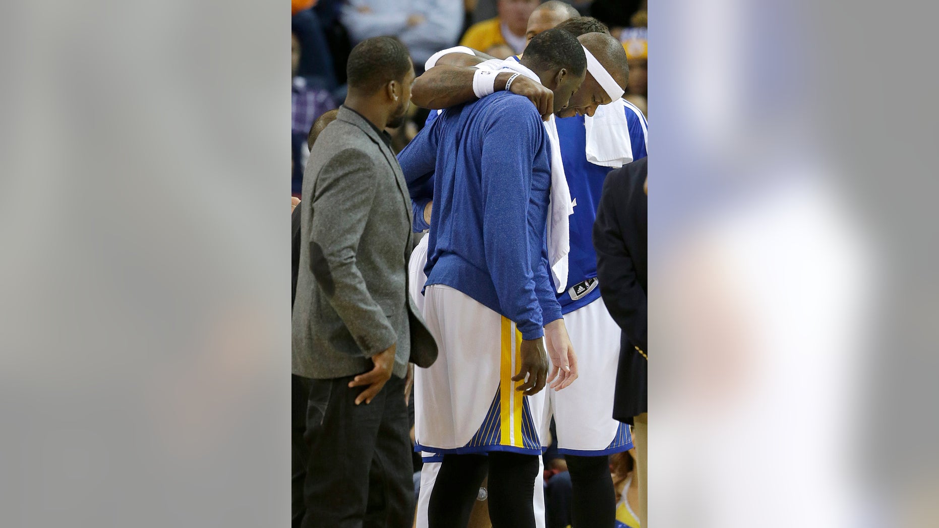 Golden State Warriors center Jermaine O'Neal, right, is helped off the floor after being injured during the fourth quarter of an NBA basketball game against the Utah Jazz in Oakland, Calif., Saturday, Nov. 16, 2013. The Warriors won 102-88. (AP Photo/Jeff Chiu)