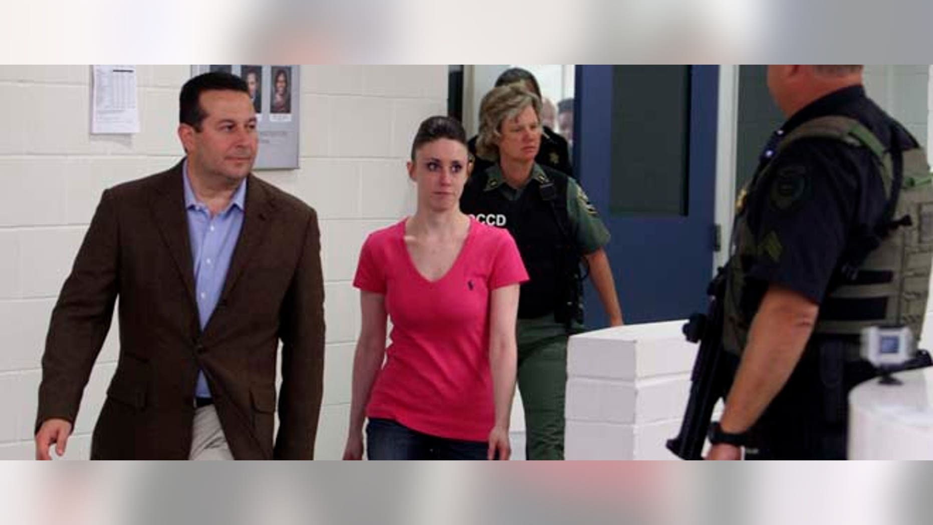 Casey Anthony, center, walks out of the Orange County Jail with her attorney Jose Baez, left, during her release in Orlando, Fla., early Sunday, July 17, 2011. Anthony was acquitted last week of murder in the death of her daughter, Caylee. (AP Photo/Red Huber, Pool)