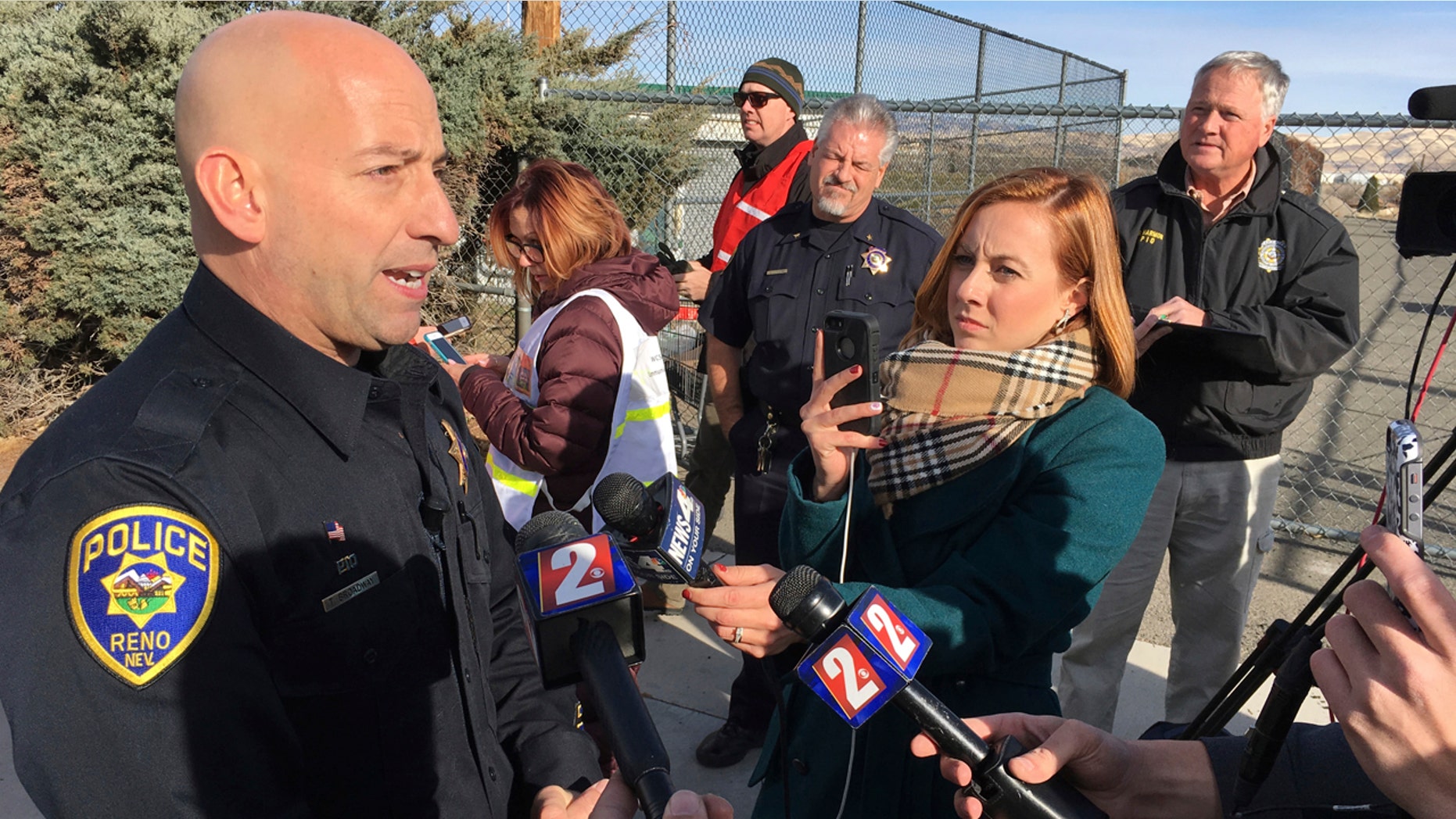 Reno police officer Tim Broadway briefs reporters outside Hug High School on the north side of Reno, Nev., on Wednesday, Dec. 7, 2016 after a Washoe County School District police officer shot a student following a disturbance at the school.