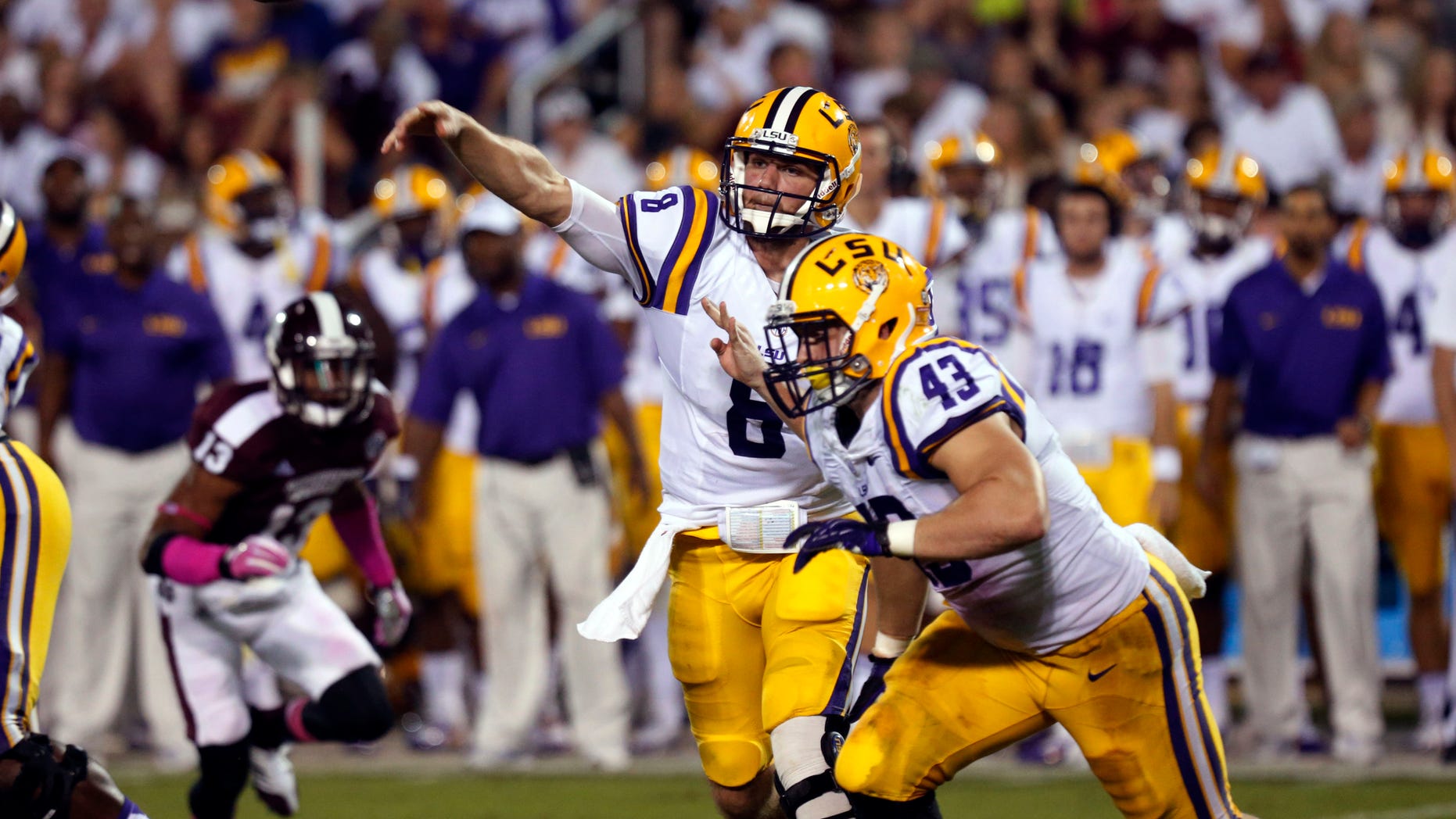 LSU quarterback Zach Mettenberger (8) throws a pass against Mississippi State as LSU fullback Connor Neighbors (43) goes past during the second half of an NCAA college football game in Starkville, Miss., Saturday, Oct. 5, 2013. No. 10 LSU won 59-26. (AP Photo/Rogelio V. Solis)