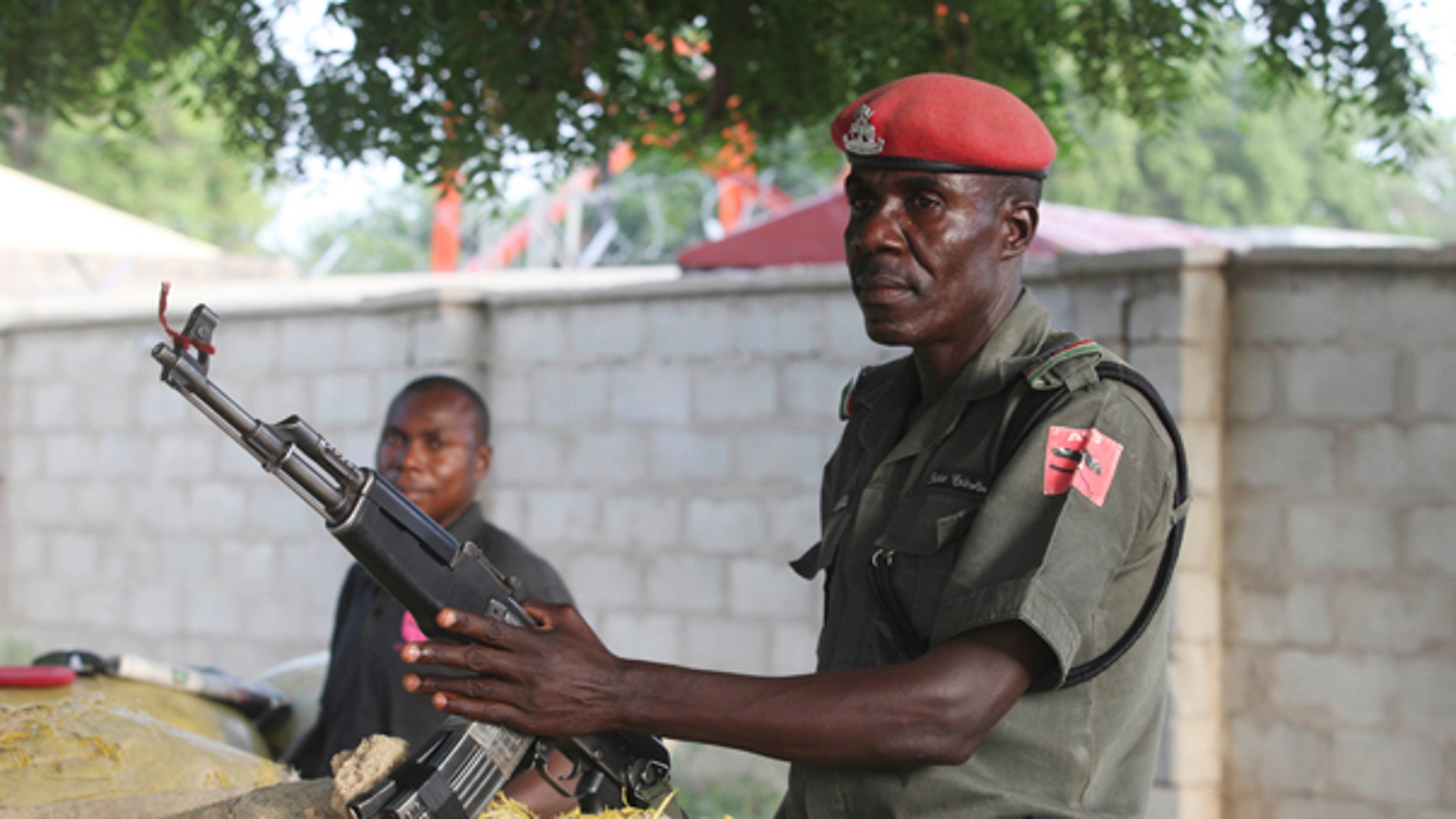 Sept. 28, 2011: olice officers armed with AK-47 rifles stand guard at sandbagged bunkers along a major road in Maiduguri, Nigeria. The radical sect Boko Haram, which in August 2011 bombed the United Nations headquarters in Nigeria, is the gravest security threat to Africa's most populous nation and is gaining prominence.