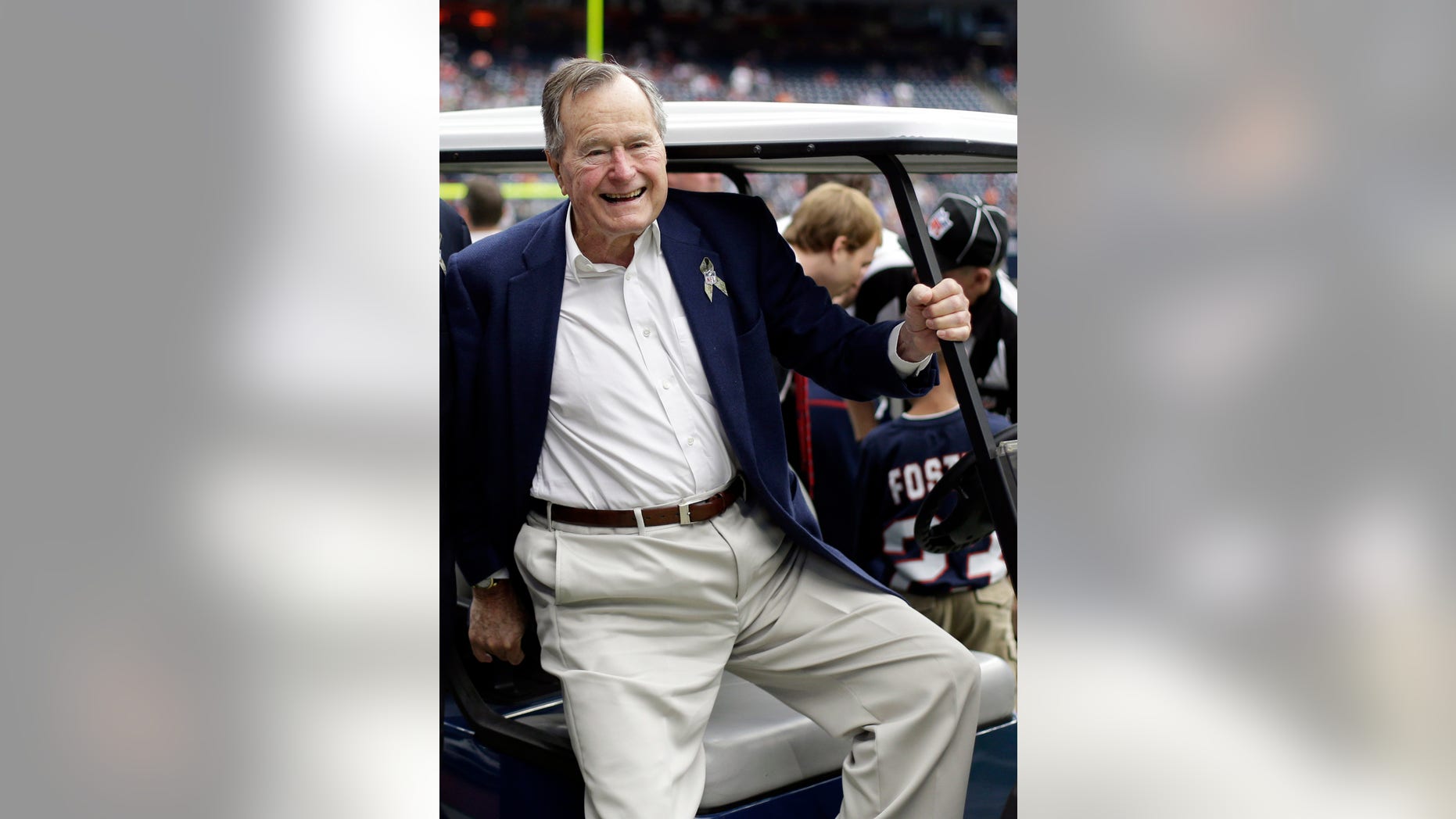 FILE - In this Nov. 4, 2012 file photo, former president George H.W. Bush pauses for a photo before an NFL football game in Houston between the Buffalo Bills and the Houston Texans. A family spokesman said Monday, Jan. 14, 2013 that Bush may be going home this week after nearly two months in a Houston hospital for treatment of a bronchitis-related cough and other health issues. (AP Photo/Eric Gay, File)