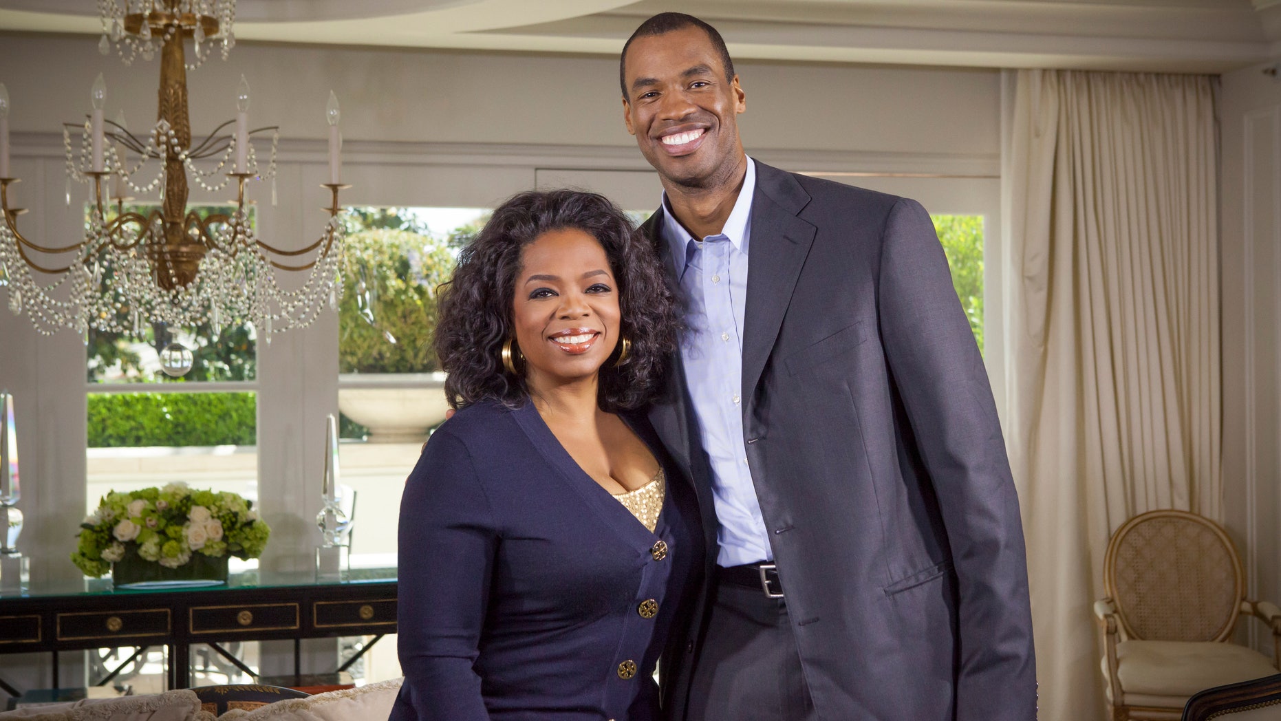 This May 1, 2013 photo released by OWN shows host Oprah Winfrey posing with NBA basketball player Jason Collins during an interview for "Oprah's Next Chapter," in Beverly Hills, Calif. The interview aired Sunday. Officials at three publishing houses said Monday, May 6, that they had been contacted about a planned memoir by Collins, the first active player in any of four major U.S. professional sports leagues to come out as gay. (AP Photo/OWN, Chuck Hodes)