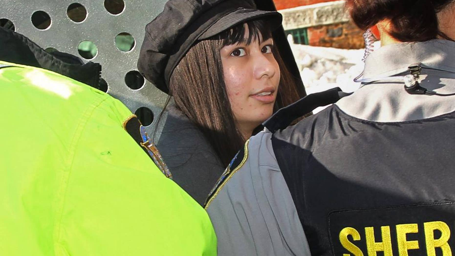 Lindsay Souvannarath arrives at provincial court in Halifax, Nova Scotia, on Tuesday, Feb. 17, 2015. Souvannarath and Randall Steven Shepherd, of Halifax, are charged with conspiracy to commit murder, allegedly plotting a Valentine's Day mass shooting at the Halifax Shopping Centre. (AP Photo/The Canadian Press, Tim Krochak)
