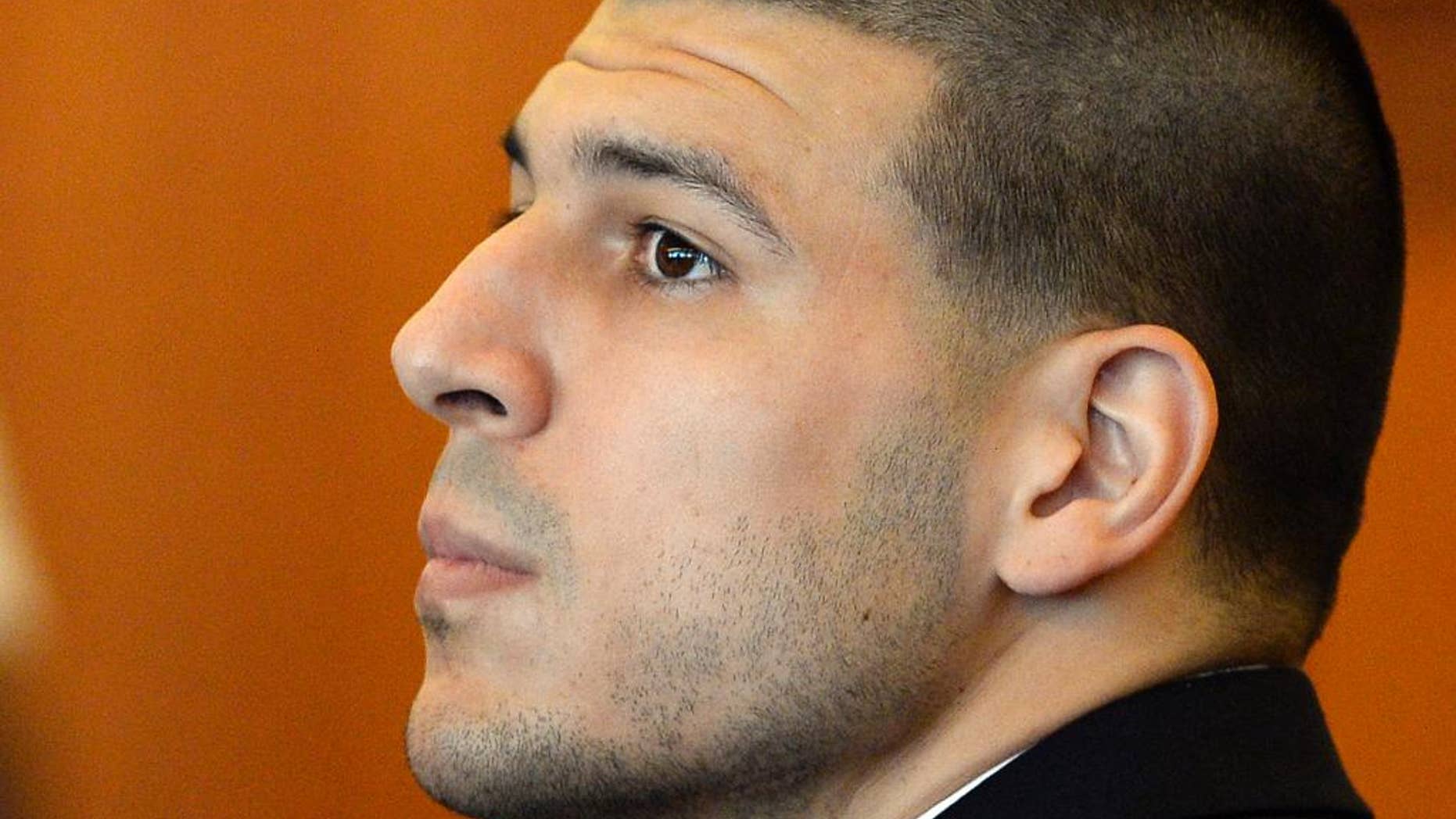 FILE - In this Tuesday, July 22, 2014, file photo, former NFL football player Aaron Hernandez watches during a hearing in Bristol County Superior Court, in Fall River, Mass. A judge is hearing arguments, Tuesday, Sept. 30, 2014, on a bid by Hernandez's lawyers to have additional evidence in a murder case against him thrown out. (AP Photo/CJ Gunther, Pool, File)