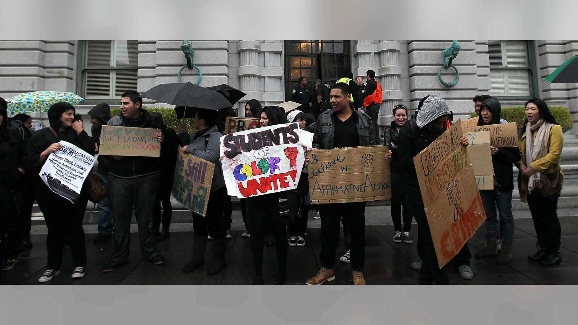 SAN FRANCISCO, CA - FEBRUARY 13: Students hoping for a repeal of California's Proposition 209 hold signs as they protest outside of the Ninth U.S. Circuit Court of Appeals on February 13, 2012 in San Francisco, California.
