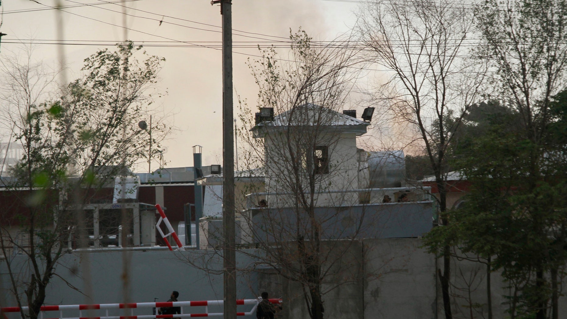 Smoke and dust rises from a building, unseen in distance, which is occupied by Taliban insurgents during a coordinated assault in Kabul, Afghanistan, on Tuesday, Sept. 13, 2011. Taliban insurgents fired rocket-propelled grenades and assault rifles at the U.S. Embassy, NATO headquarters and other buildings in the heart of the Afghan capital Tuesday while suicide bombers struck police buildings. The U.S. Embassy and NATO reported no casualties. (AP Photo/Musadeq Sadeq)
