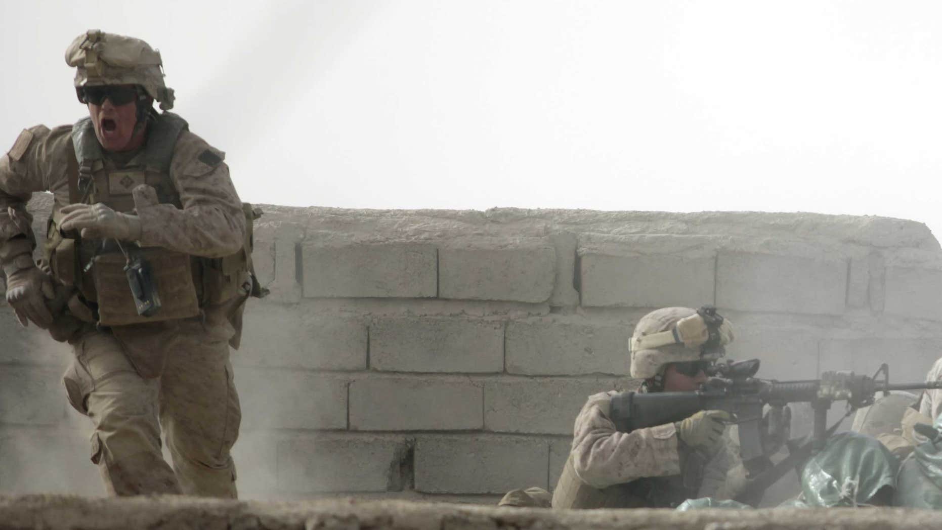 Feb. 14: A U.S. Marine from Bravo Company of the 1st Battalion, 6th Marines runs during a heavy gun battle in the town of Marjah, Afghanistan.