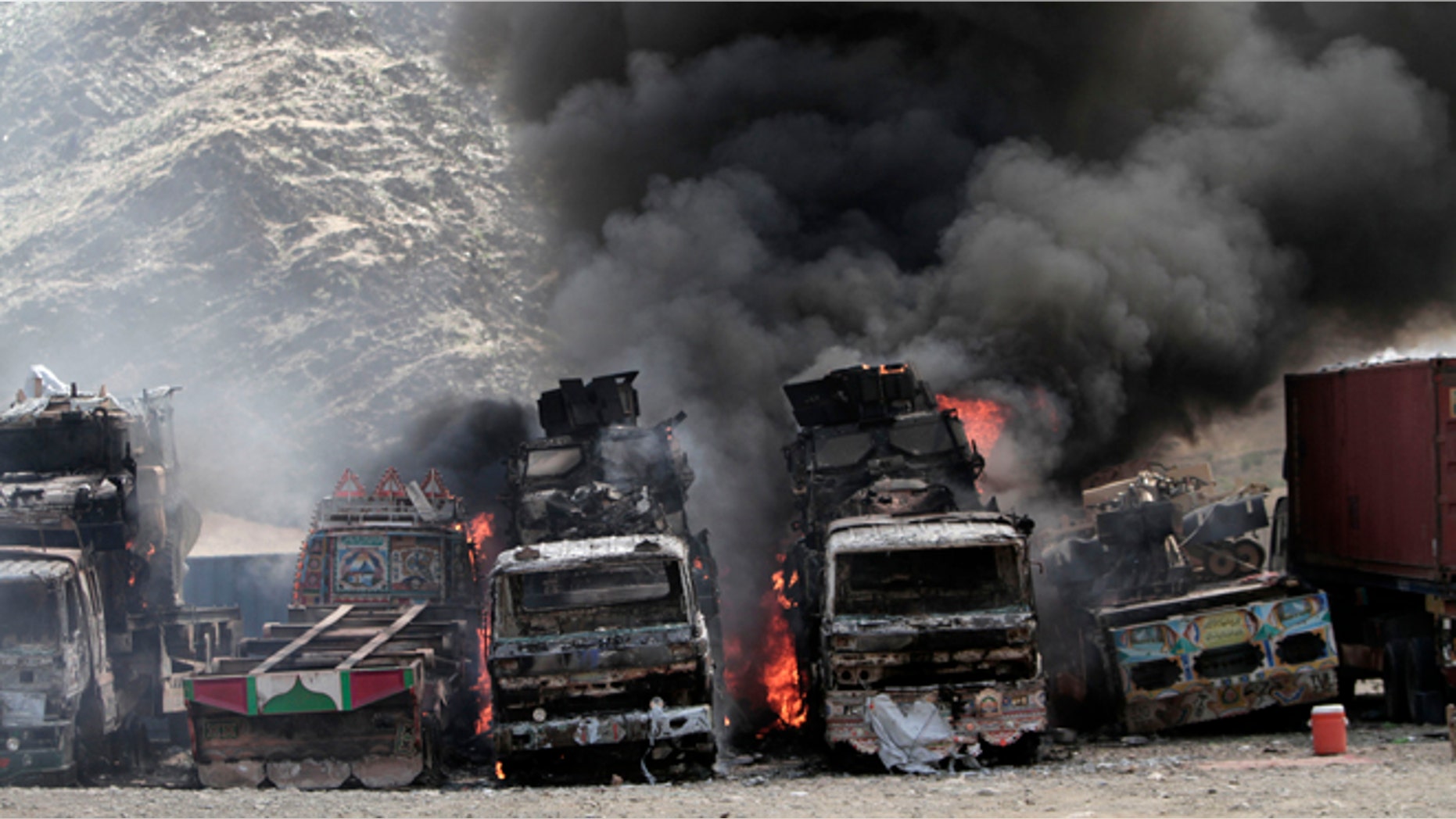 Sept. 2, 2013: Smoke rises from NATO supply trucks following an attack by militants in the Torkham area near the Pakistan-Afghanistan border in Jalalabad province east of Kabul, Afghanistan. The Taliban claimed responsibility for the strike on a U.S. base in Afghanistan near the border with Pakistan on Monday, setting off bombs, torching vehicles and shutting down a key road used by NATO supply trucks, officials said. Several people -- apparently all attacking insurgents -- were killed. (AP/Rahmat Gul)