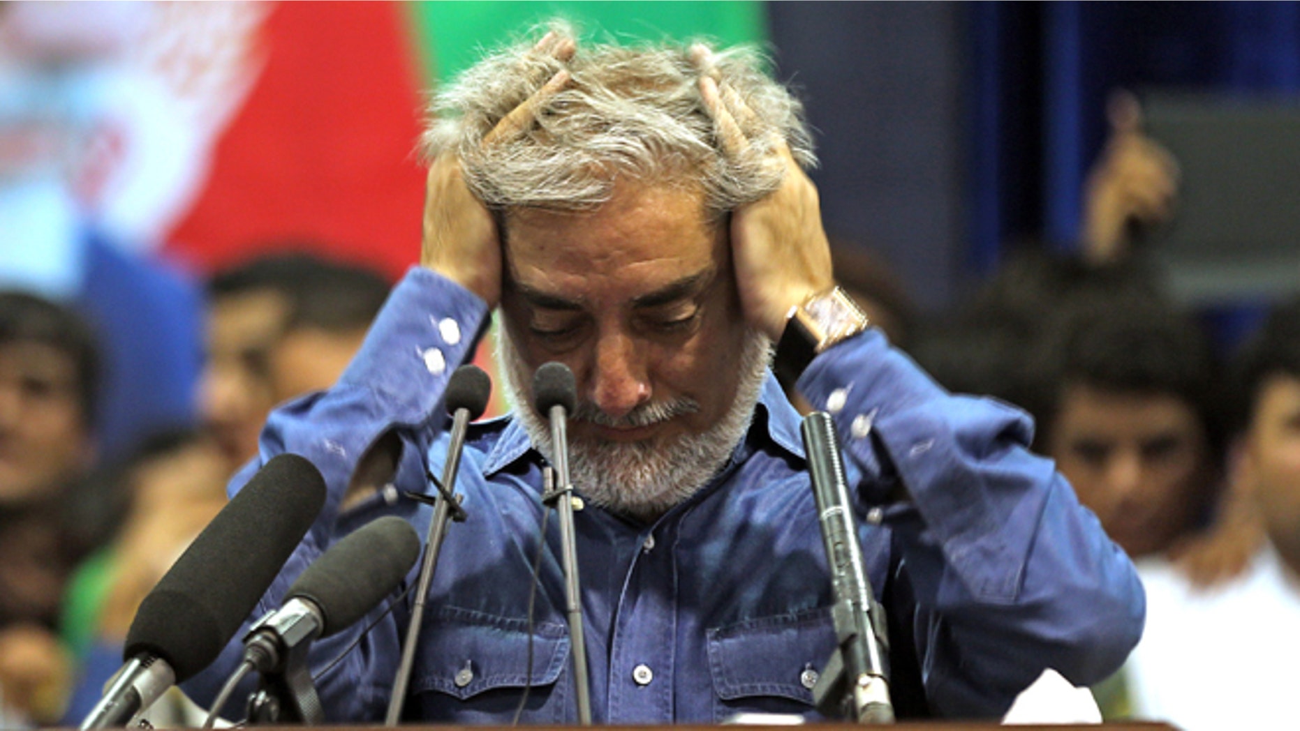 July 8, 2014: Afghan presidential candidate Abdullah Abdullah runs his hands through his hair as he pauses in addressing his supporters in Kabul, Afghanistan. (AP)