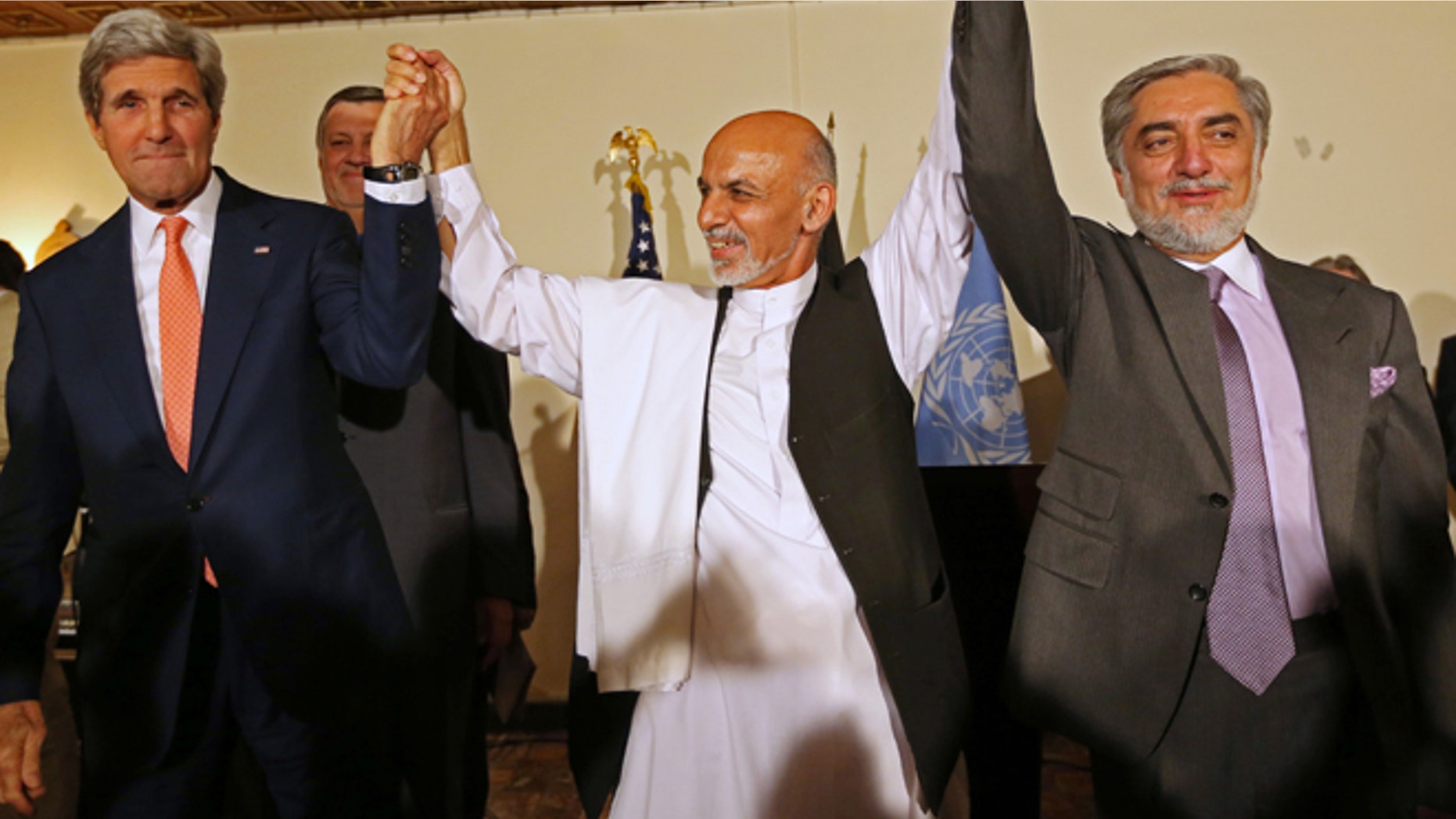 This July 12, 2014 file photo shows. from left, Secretary of State John Kerry, Afghanistan's presidential candidate Ashraf Ghani Ahmadzai, and Afghan presidential candidate Abdullah Abdullah during a joint news conference in Kabul, Afghanistan.