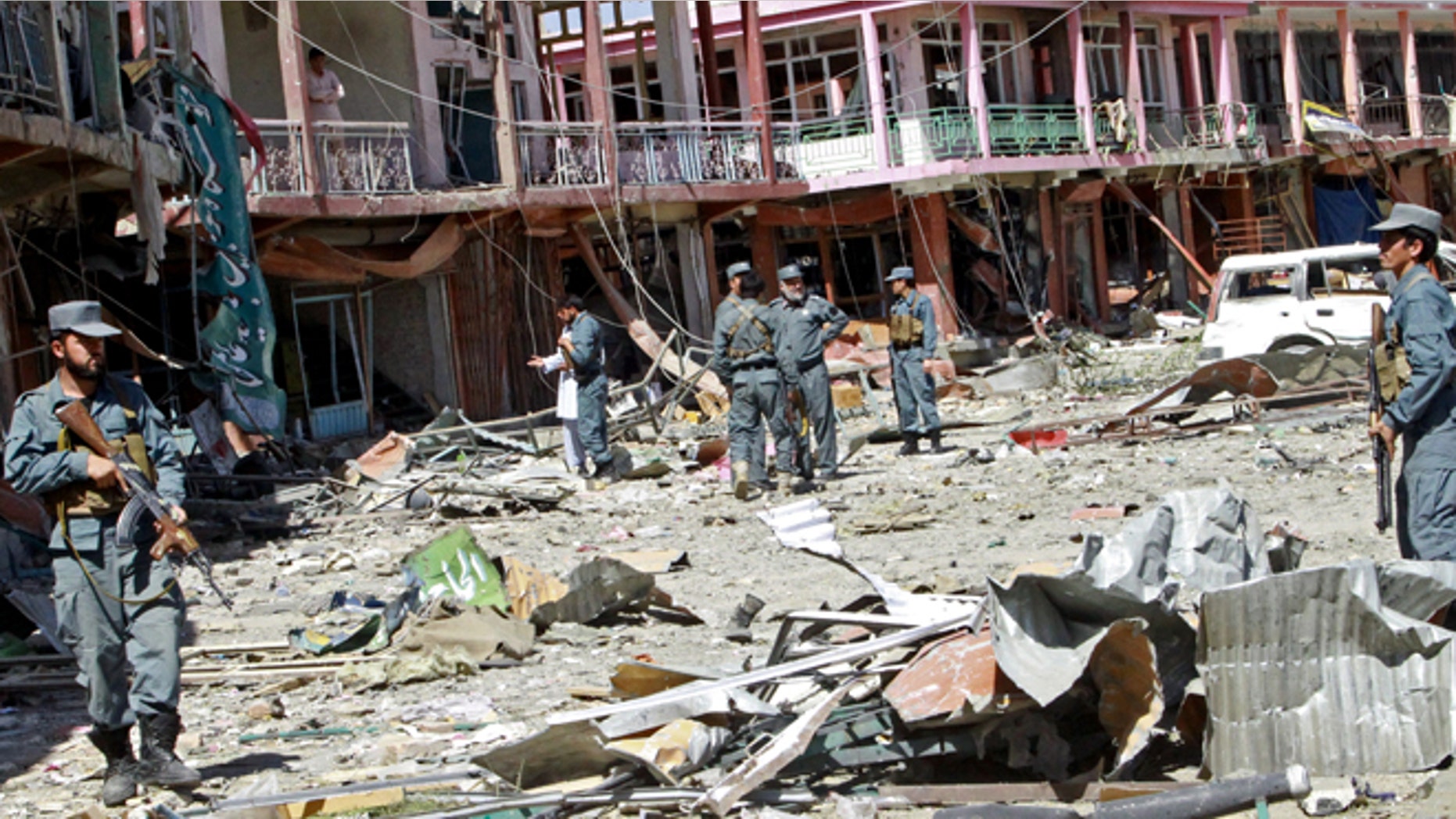 Sept. 4, 2014: Afghan security forces walk at the site of a suicide attack in Ghazni, Afghanistan. The Taliban struck a government compound in eastern Afghanistan early on Thursday in an attack that included two suicide truck bombings and left nearly a dozen dead, including several off duty policemen asleep in their quarters nearby, officials said.