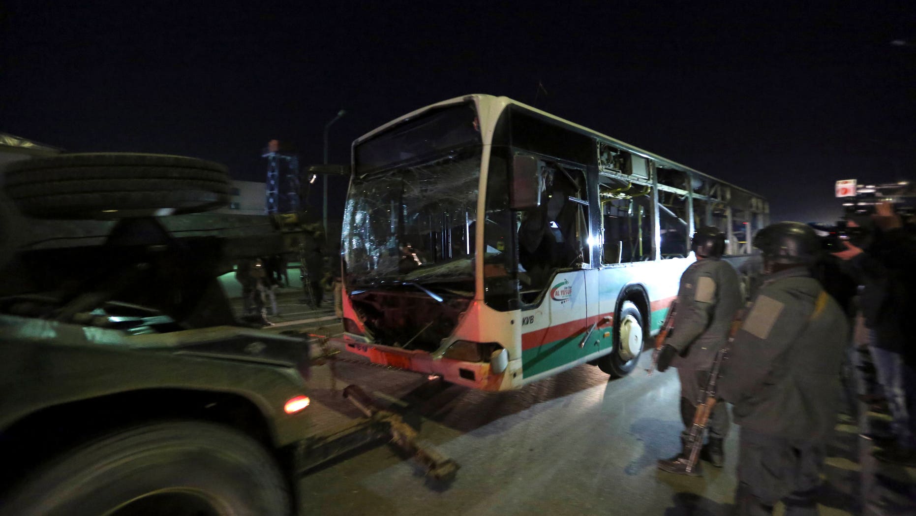 Afghan security forces remove a large vehicle after twin bombings in Kabul, Afghanistan.