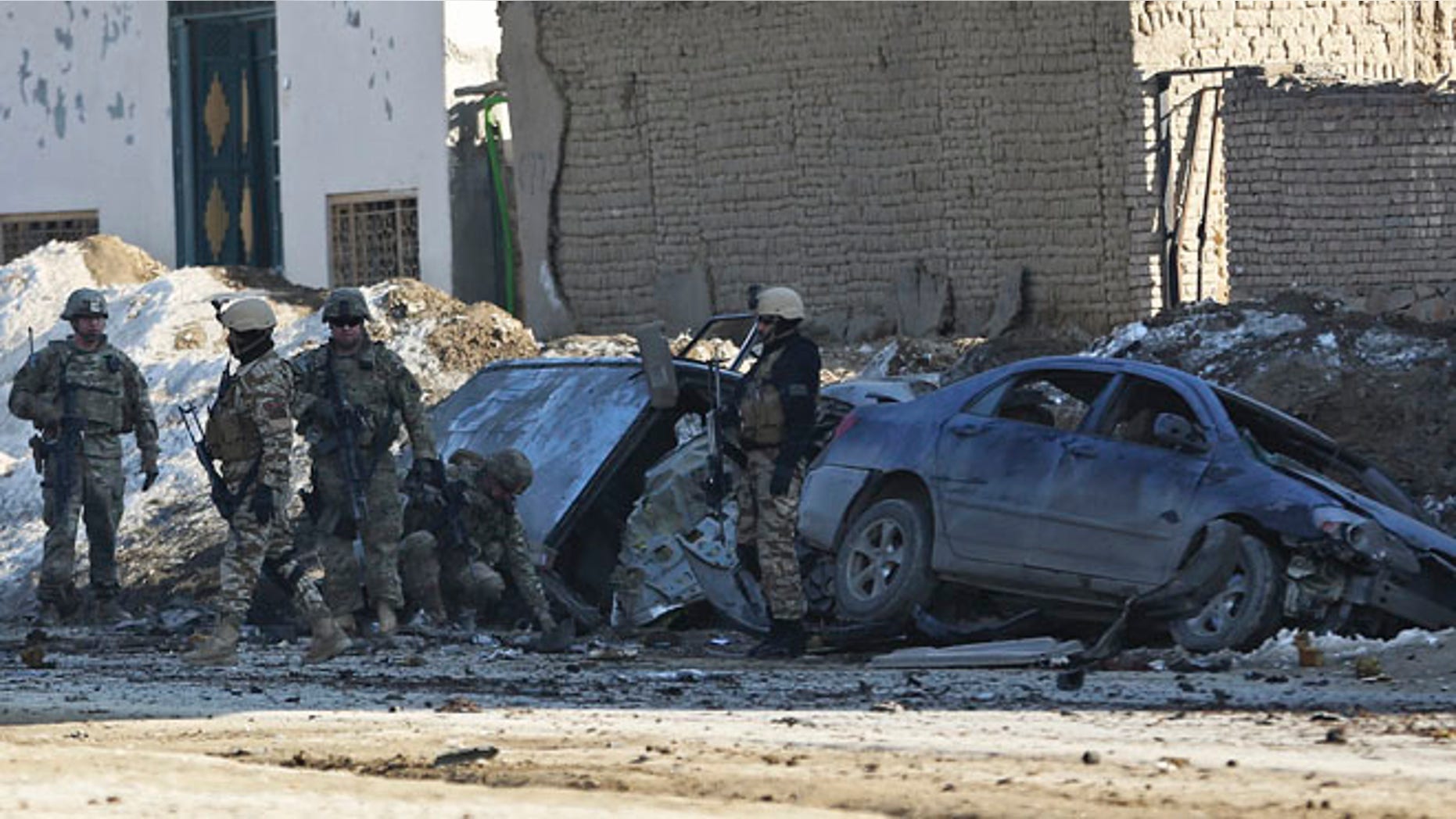 Feb. 10, 2014: U.S. soldiers and Afghan security forces search the site of a suicide bombing that struck near a NATO convoy in the Afghan capital Kabul, Afghanistan.