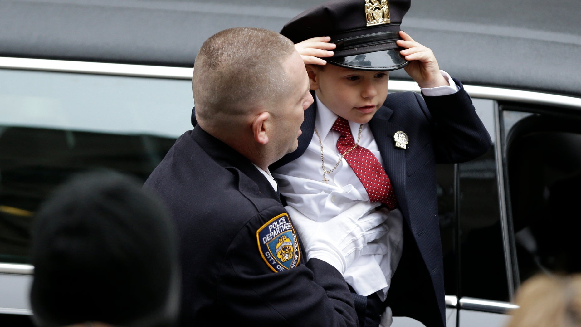 Ryan Lemm, 4, son of Joseph Lemm, arrives for his father's funeral.