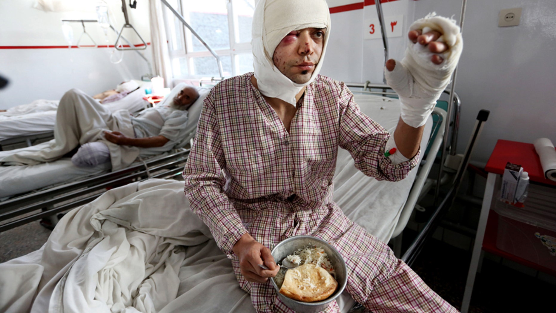 Jan. 21, 2016: An injured victim from Wednesday's suicide attack near the Russian Embassy, tries to eat at a hospital in Kabul, Afghanistan.