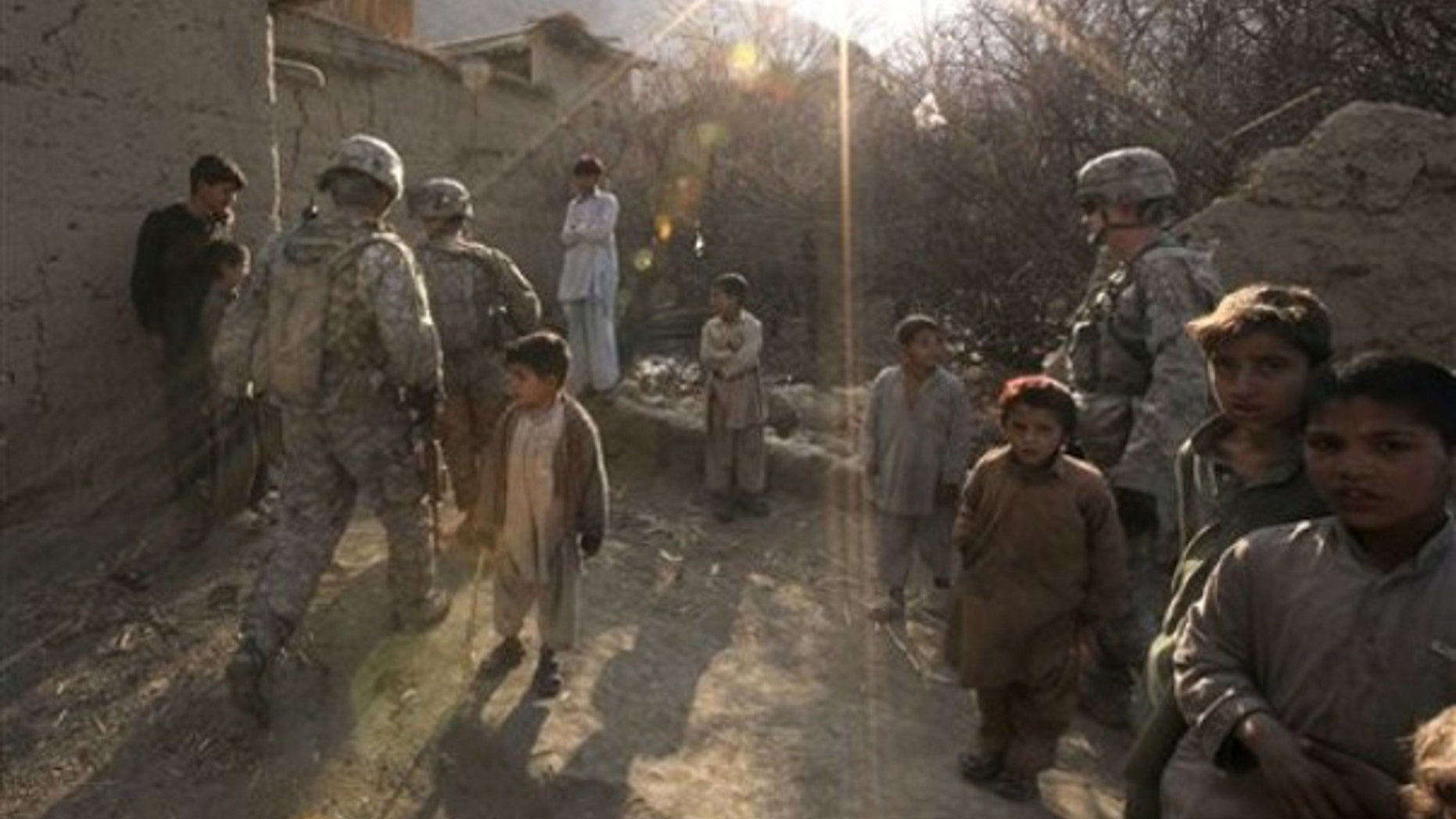 Sunday: U.S. Army soldiers patrol inside Pech Valley, Kunar province, in northeastern Afghanistan. Private consultants Checchi & Company won a no-bid contract from the Obama administration to 'train the next generation of legal professionals' in Afghanistan. (AP)