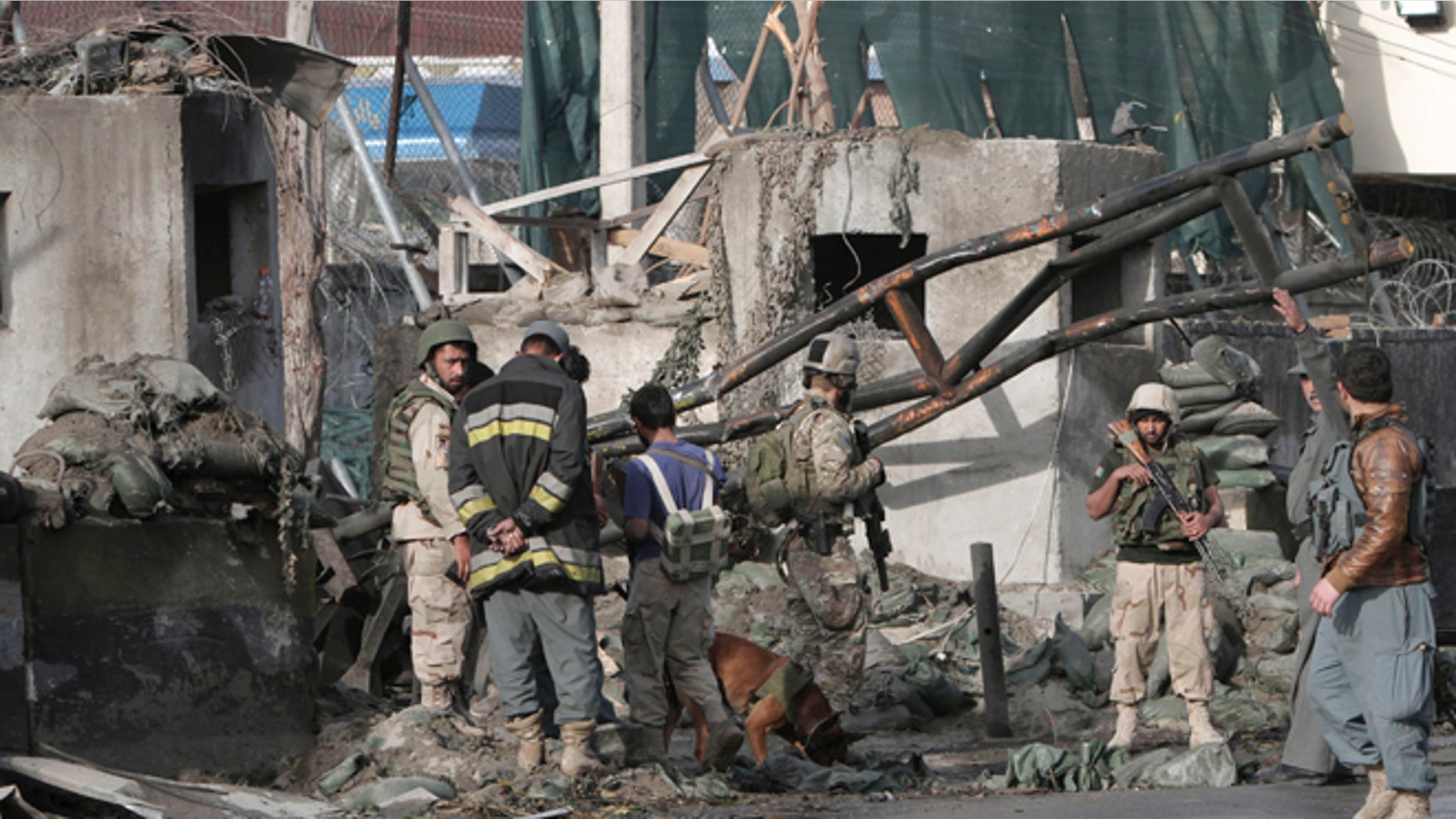 March 26, 2013: Afghan police and U.S. forces arrive to the scene after eight suicide bombers attacked a police headquarters in the eastern Afghan city of Jalalabad, Afghanistan, killing five police officers and wounding four others, a security official said. An insurgent in a bomb-laden car detonated his vehicle in front of the Jalalabad Police Quick Reaction Force to start the attack, and another seven attackers wearing bomb vests then stormed the compound.