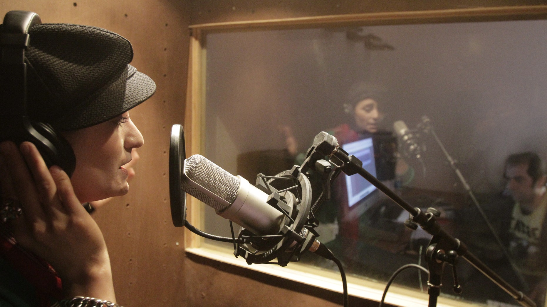 Oct. 3, 2012: In this photo, Afghanistan's first female rapper Sosan Firooz sings in a studio in Kabul, Afghanistan. Firooz, 23-year-old singer is making history in her homeland where society frowns on women who take the stage.