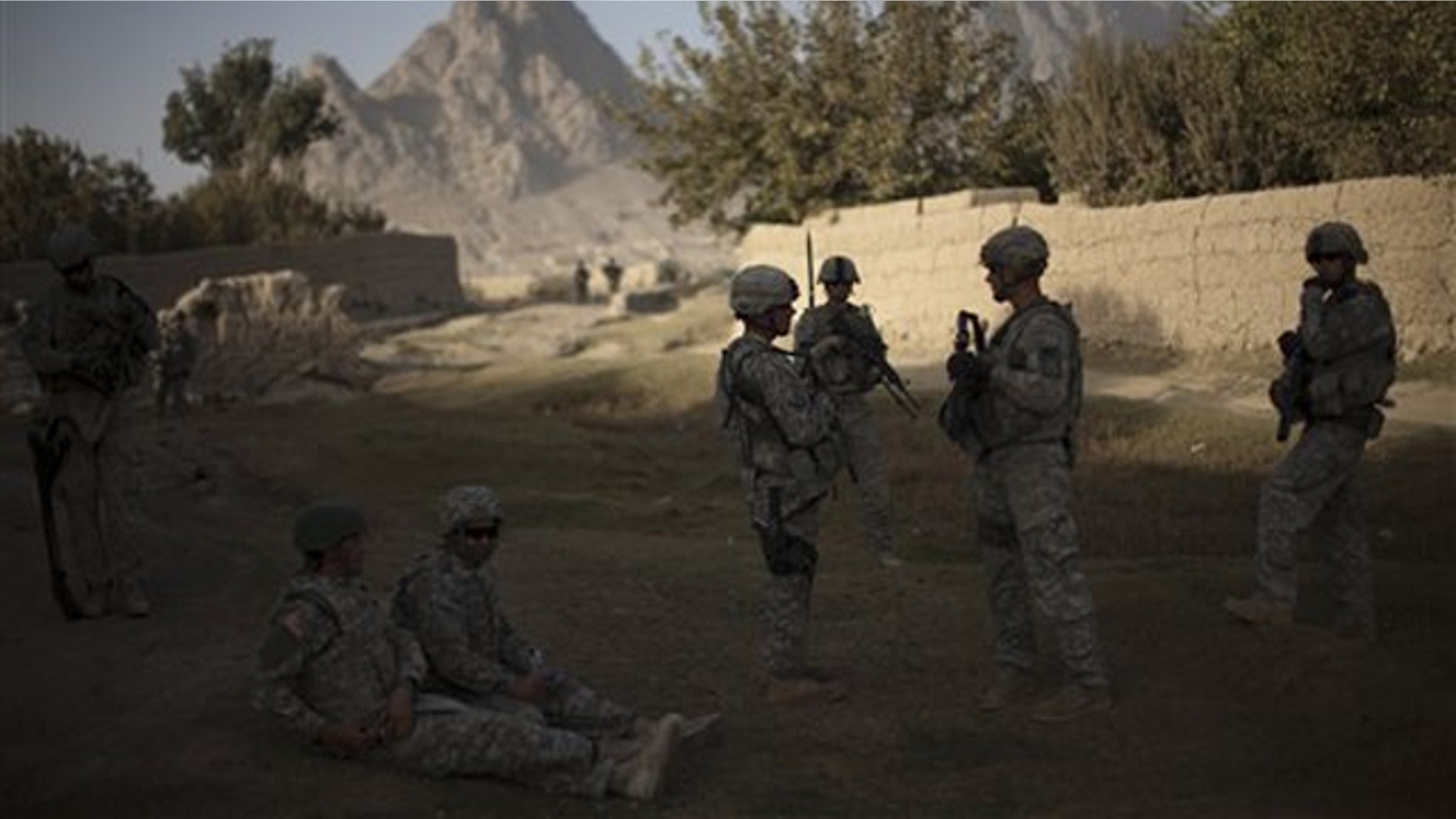 In this Oct. 24 photo, U.S. soldiers from 2nd PLT Diablos 552nd Military Police Company patrol the outskirts of Kandahar City in Afghanistan. (AP Photo)