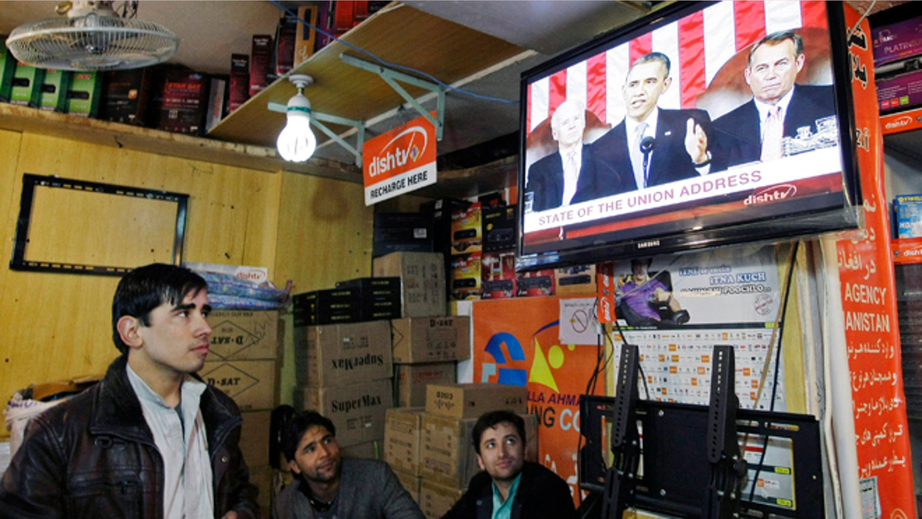 Feb. 13, 2013: Afghan men watch a television news report on U.S. President Barack Obama's State of the Union address in Kabul, Afghanistan Wednesday.