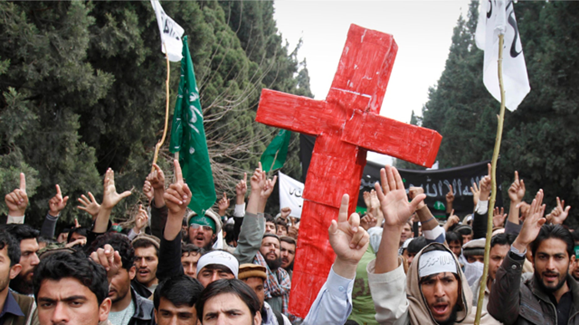 March 13, 2012: Protesters east of Afghanistan's capital of Kabul shout slogans against the United States while carrying a red cross after the killing of 16 Afghan civilians allegedly by an American soldier in Panjwai, in the province of Kandahar.