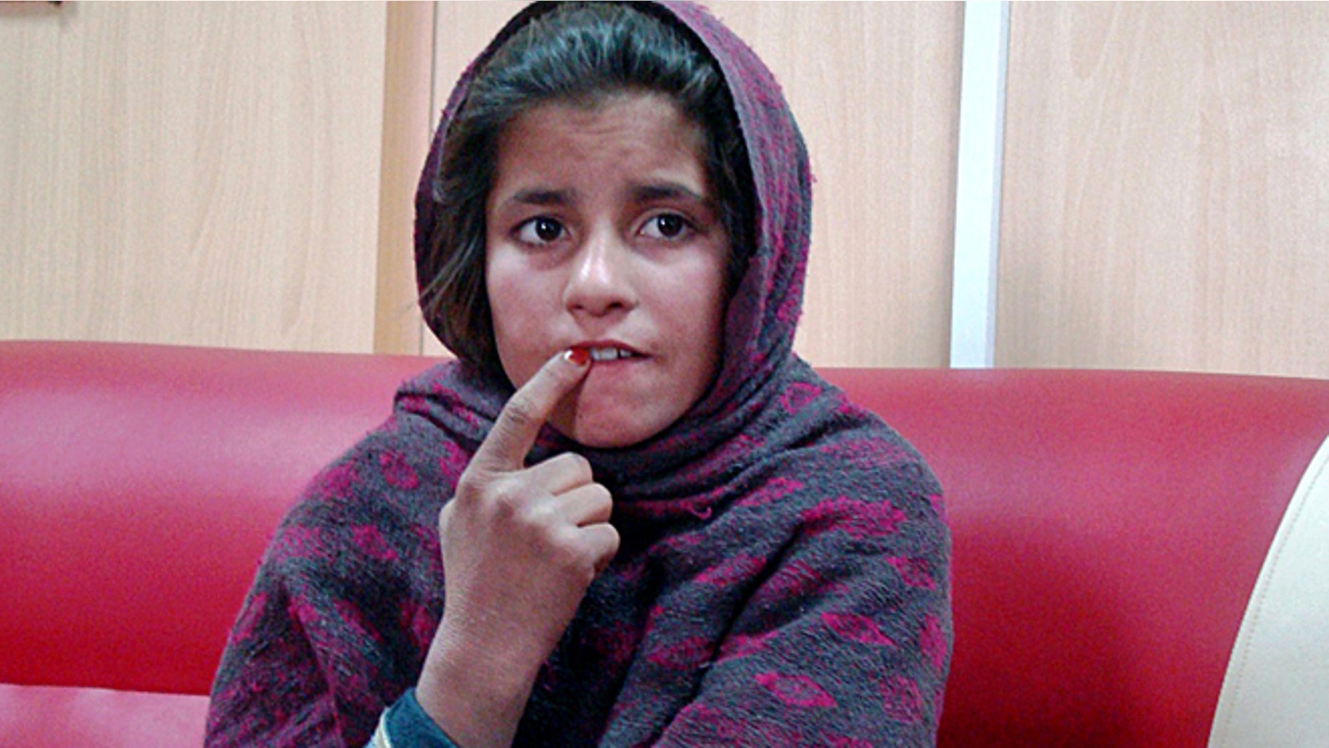 Jan. 6, 2014: In this photo, an Afghan girl named Spozhmai is held in a border police station in the Khan Neshin district in the southeastern part of Helmand province, Afghanistan.