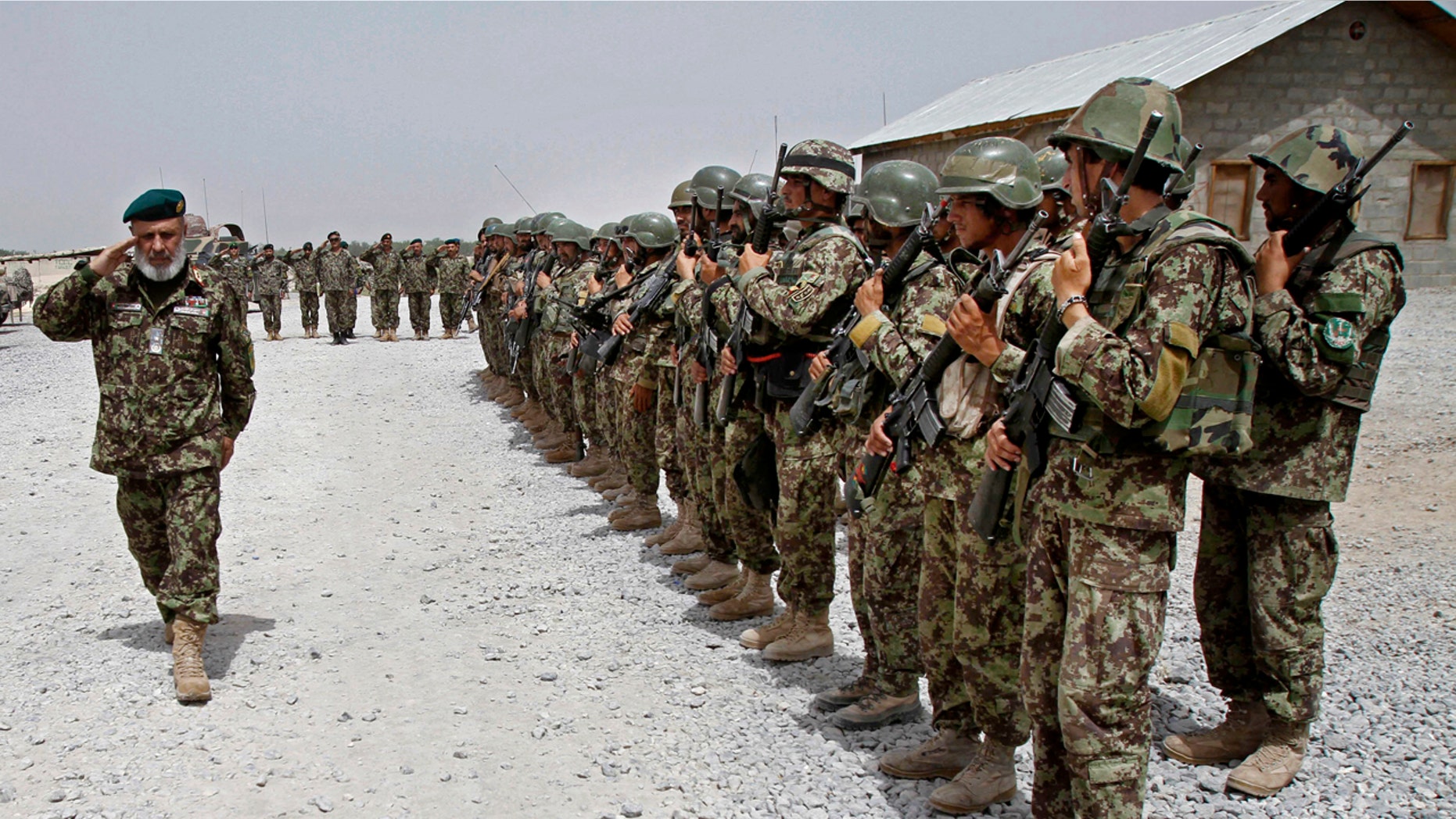 In this Thursday, June 13, 2013 file photo, Afghan National Army soldiers stand in position, in the Sangin district of Kandahar province, southern Afghanistan.