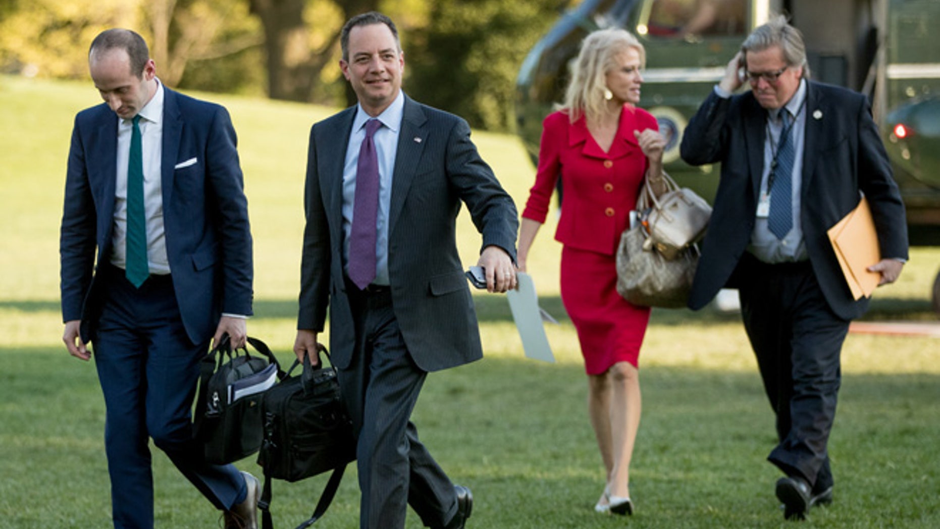 From left, President Donald Trump's White House Senior Adviser Stephen Miller, President Donald Trump's Chief of Staff Reince Priebus, Counselor to the President Kellyanne Conway, and President Donald Trump's White House Senior Adviser Steve Bannon, walk across the South Lawn after President Donald Trump arrives at the White House in Washington, Tuesday, April 18, 2017, after a short trip from Andrews Air Force Base, Md., after speaking at Snap-On Tools in Kenosha, Wis. (AP Photo/Andrew Harnik)