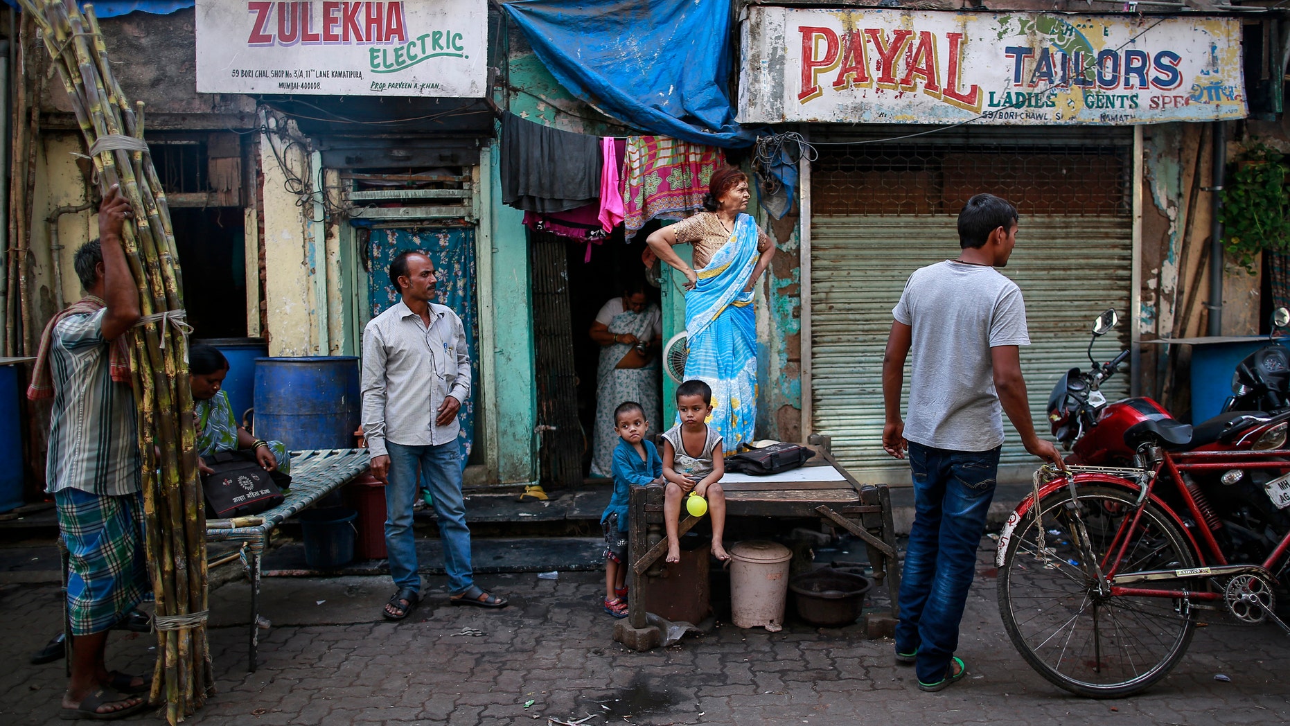 Dec. 1, 2014: People watch a street performance to mark World AIDS Day in Kamathipura, Mumbai's red light district.