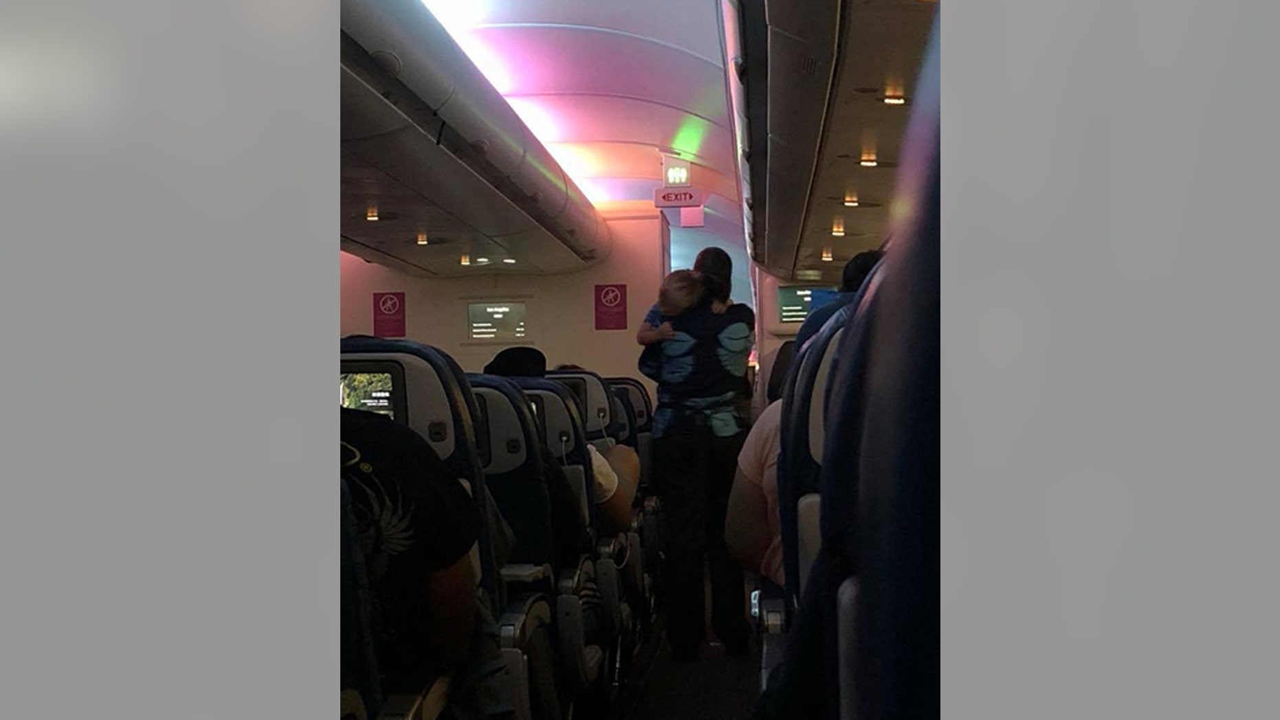 A mother traveling alone with her three small children struggled to comfort her youngest, which led to a flight attendant offering to lend a helping hand, or two.