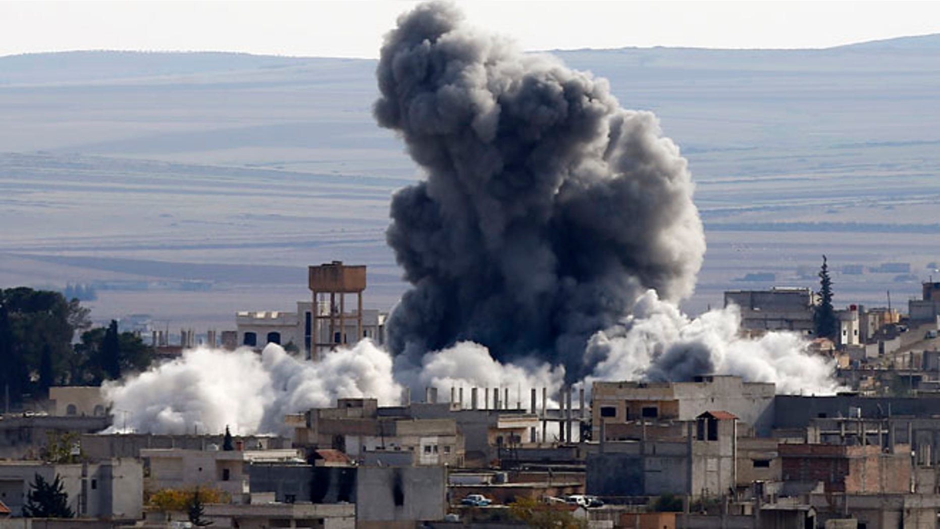 Nov. 23, 2014: An explosion following an air strike is seen in Kobani, Syria, near the Turkish border.