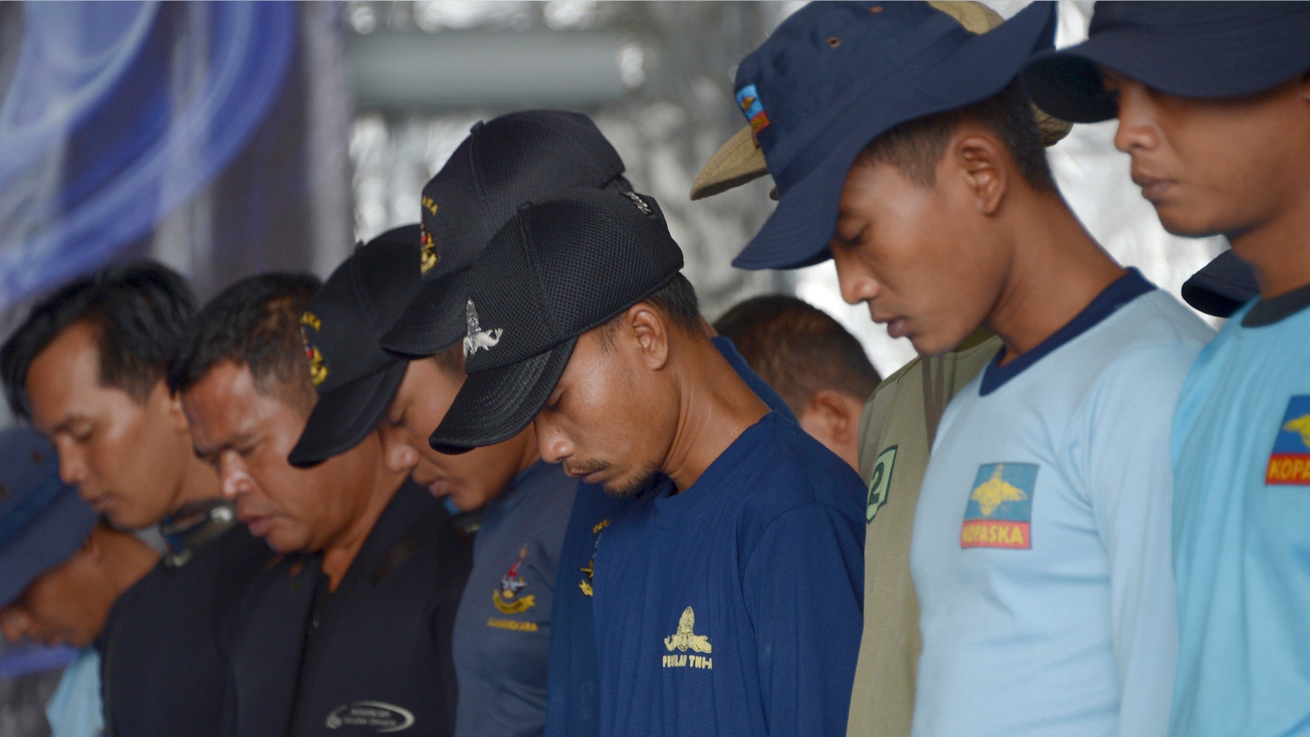 Jan. 8, 2015: Indonesian navy divers pray on the navy vessel KRI Banda Aceh prior to dive in an area where a team found the tail of AirAsia Flight 8501 on the Java Sea.