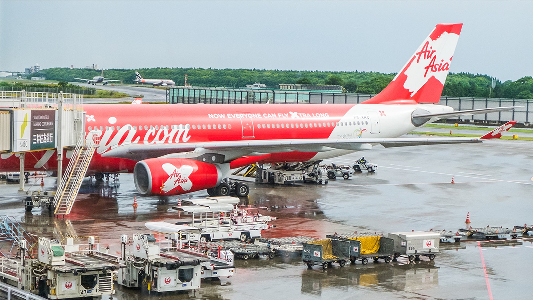AirAsia employees were seen hugging and kissing suitcases in bizarre photos after video of them mishandling luggage went viral.