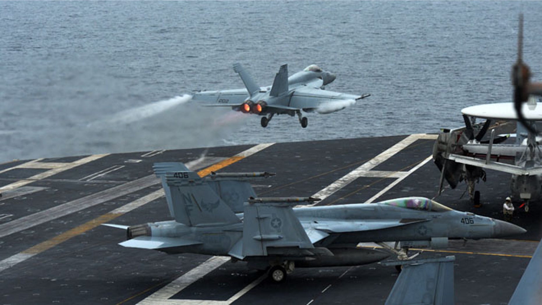A U.S. F18 Hornet fighter attack aircraft is launched off the deck of the U.S. nuclear-powered aircraft carrier, USS George Washington during a military exercise off South Korea's West Sea, Wednesday, July 16, 2014.