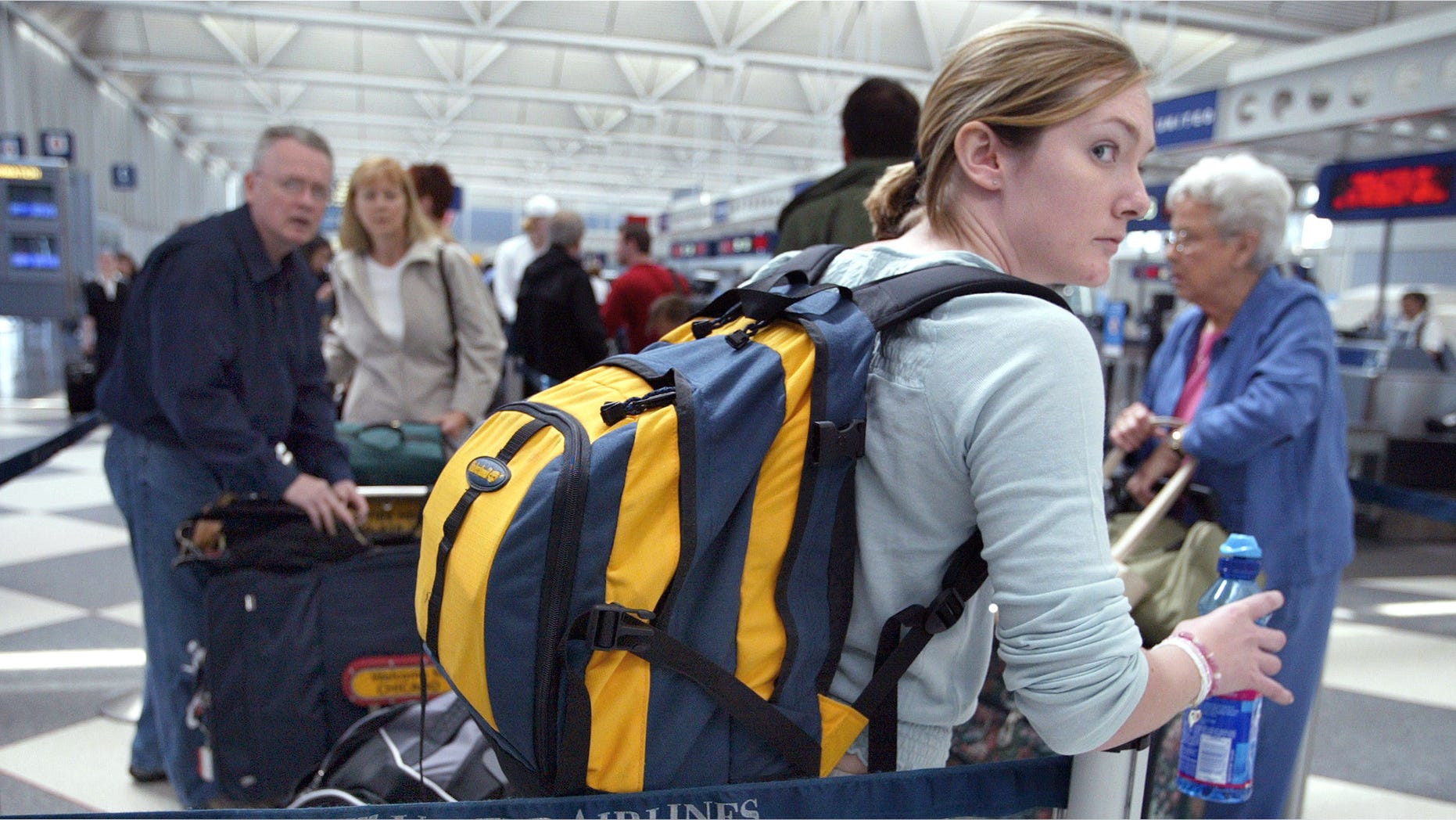 CHICAGO, IL - MAY 21: Travelers stand in line at the United Airlines Terminal at O'Hare International Airport May 21, 2003 in Chicago, Illinois. The airlines said that it is weighing whether to emerge from bankruptcy months ahead of schedule. Analysts say the company has obstacles to overcome before it can operate outside of court protection. (Photo by Tim Boyle/Getty Images)