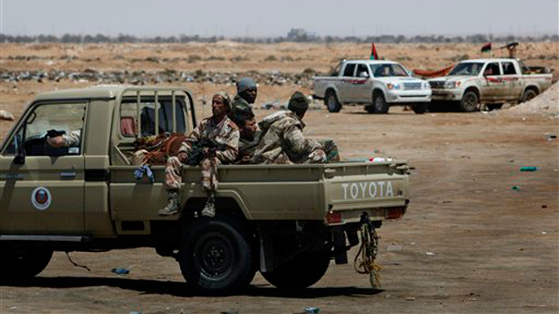 Libyan rebel fighters patrol along the western gate of Ajdabiya, Libya, April 23.