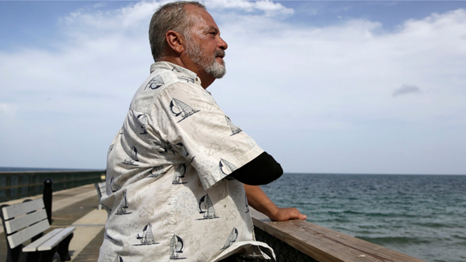 Aug. 5, 2015: Al Brennaka, 57, poses for a photograph in Pompano Beach, Fla. Brennaka lost half his arm at age 19 after being attacked by a shark while surfing off Daytona Beach.