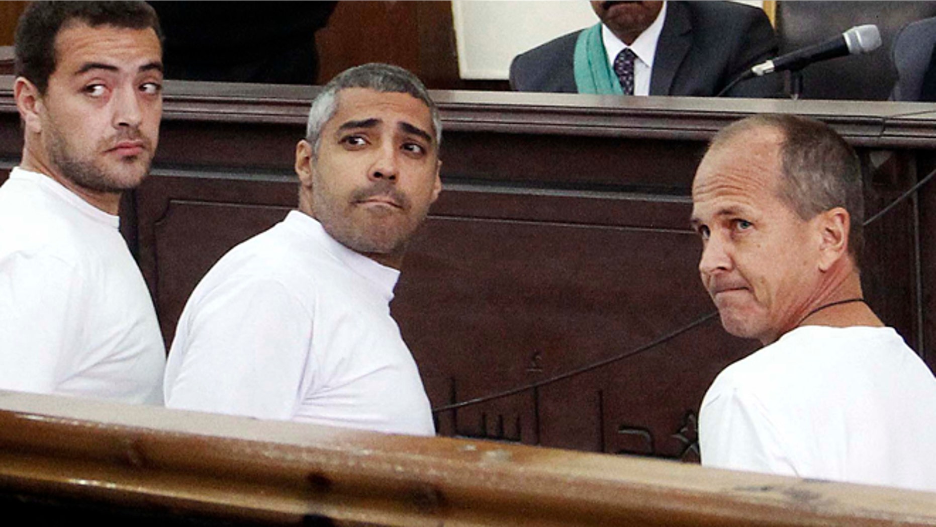 March 31, 2014: In this file photo, Al-Jazeera English producer Baher Mohamed, left, Canadian-Egyptian acting Cairo bureau chief Mohammed Fahmy, center, and correspondent Peter Greste, right, appear in court along with several other defendants during their trial on terror charges, in Cairo, Egypt. An Egyptian court on Monday, June 23, 2014, convicted three Al-Jazeera journalists and sentenced them to seven years in prison on terrorism-related charges after a trial dismissed by rights groups as a politically motivated sham. The verdict brought a landslide of international condemnation and calls for Egyptian President Abdel-Fattah el-Sissi to intervene. El-Sissi, on Tuesday said he will not interfere in court rulings, sparking an international outcry.