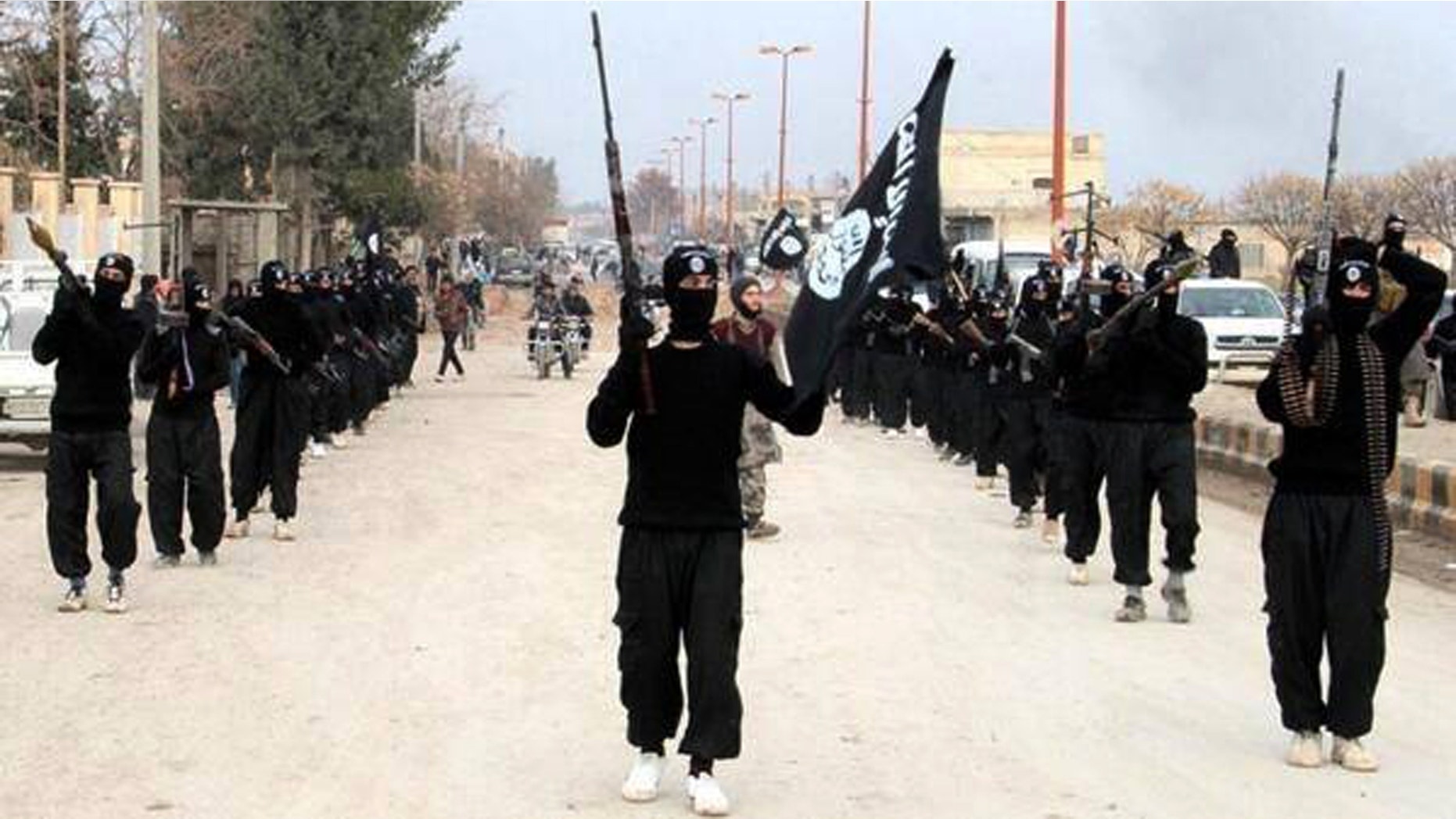 This undated image posted on a militant website on Jan. 14, 2014, shows fighters from the al Qaeda-linked Islamic State of Iraq and the Levant (ISIL) marching in Raqqa, Syria. Al Qaeda's central leadership has broken off ties with ISIL-- one of the most powerful militant groups in Syria-- and distanced itself from the rebel infighting in that country's civil war.
