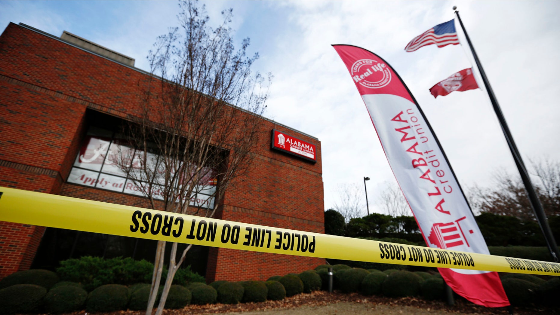 Police tape surrounds the Alabama Credit Union building after reports of a hostage standoff, Tuesday, Jan. 10, 2017, in Tuscaloosa, Ala.