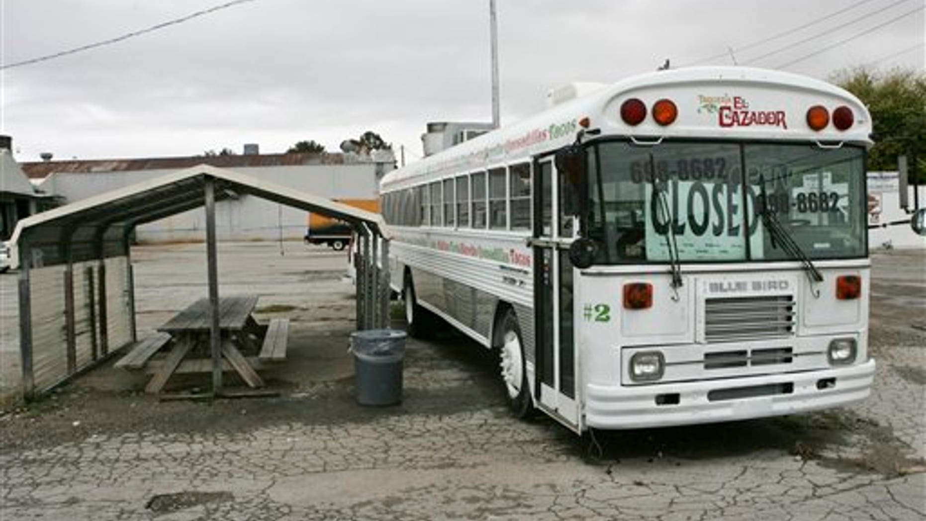 The Taqueria El Cazdor taco bus on the corner of 9th Street and Governors Drive is closed Wednesday Oct. 12, 2011 in Huntsville, Ala.. Dozens of businesses across Alabama shut down as Hispanics took a day off from work to protest against Alabama's tough new immigration law. (AP Photo/The Huntsville Times, Michael Mercier)
