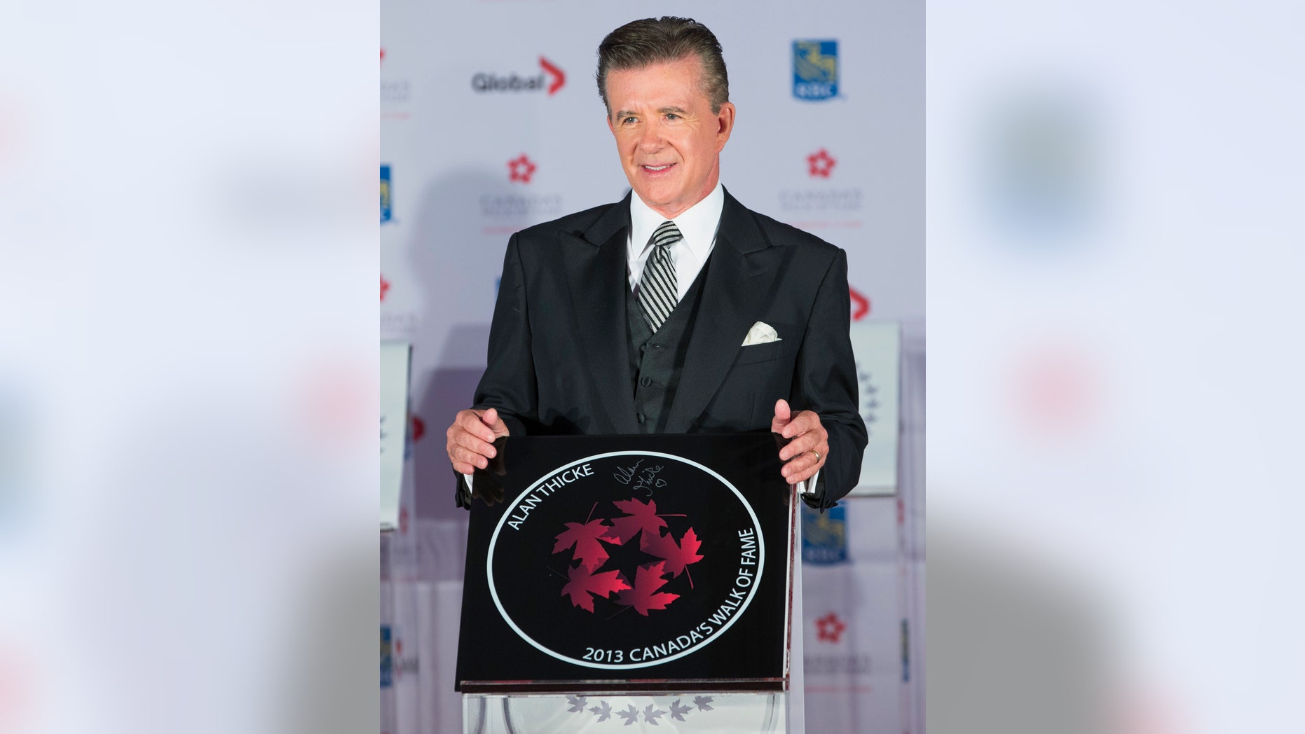 Actor Alan Thicke stands by his star during Canada's Walk of Fame induction ceremonies in Toronto, September 21, 2013. REUTERS/Mark Blinch (CANADA - Tags: ENTERTAINMENT) - RTX13TYB
