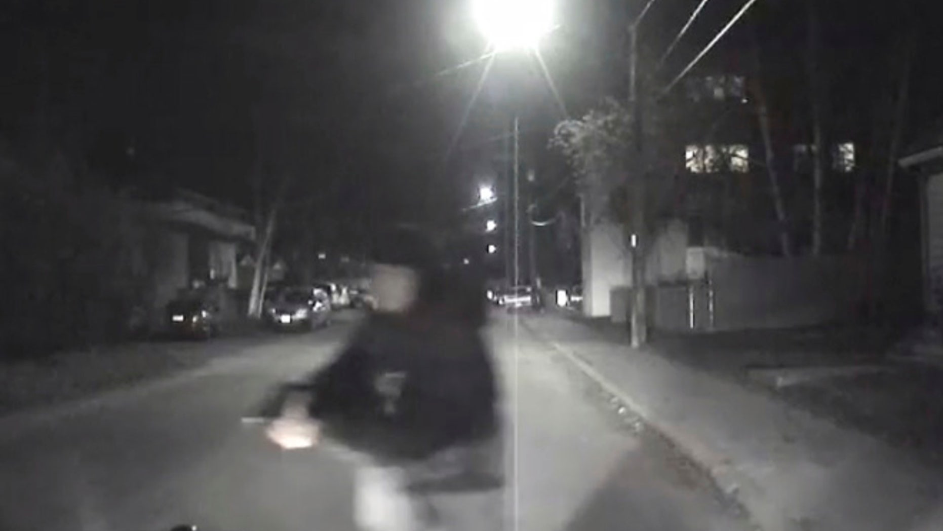 An image from video provided by the Fairbanks Police Department shows shows the suspect police believe abandoned a police car he stole after he shot an officer in Fairbanks, Ak., early Sunday, Oct. 16, 2016.